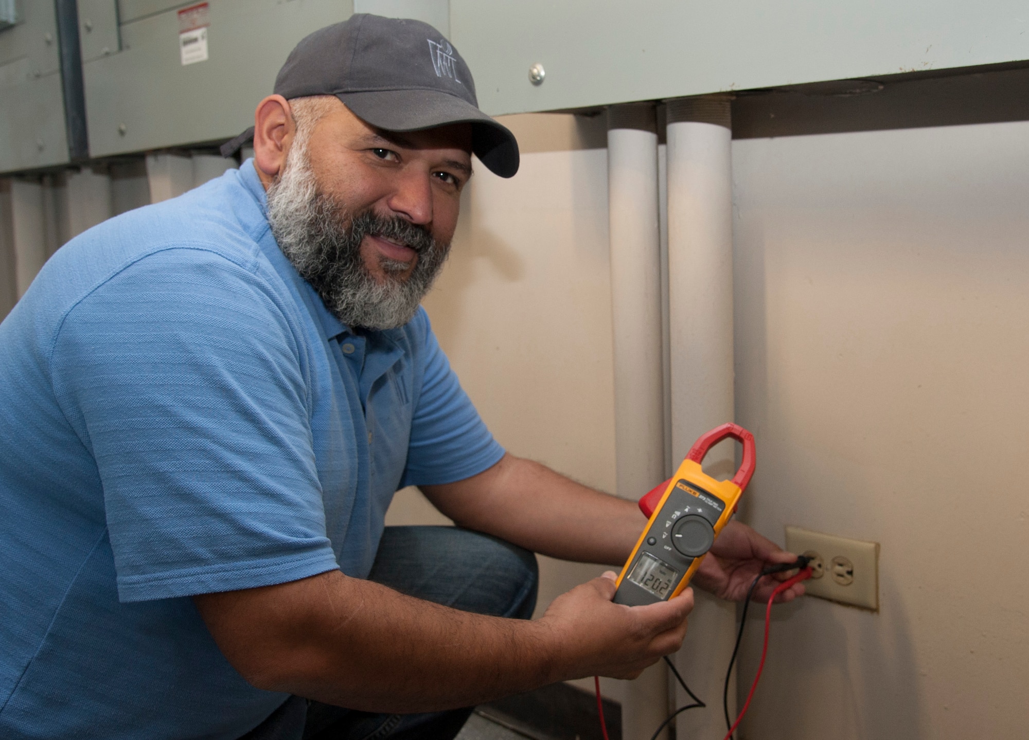 Marco Esquivel, 47th Medical Group maintenance manager, checks an outlet at the 47th MDG facility at Laughlin Air Force Base, Texas, Feb. 11, 2014. By monitoring the daily usage of electricity, water and gas, the clinic was able to save 171 tons of emissions and $23,000 in one year. (U.S. Air Force photo/2nd Lt. William M. Tyrrell)
