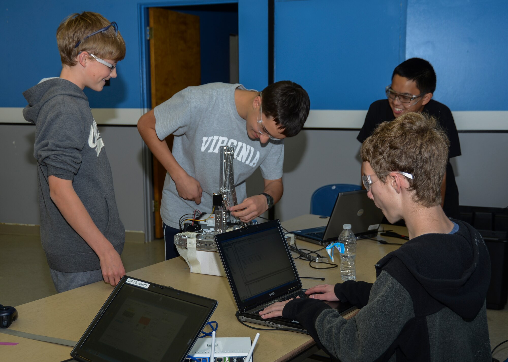 Members of the team work on fine-tuning an arm to be integrated in their robot Scoop Da Whoop for the regional championships. (U.S. Air Force photo by Rebecca Amber)