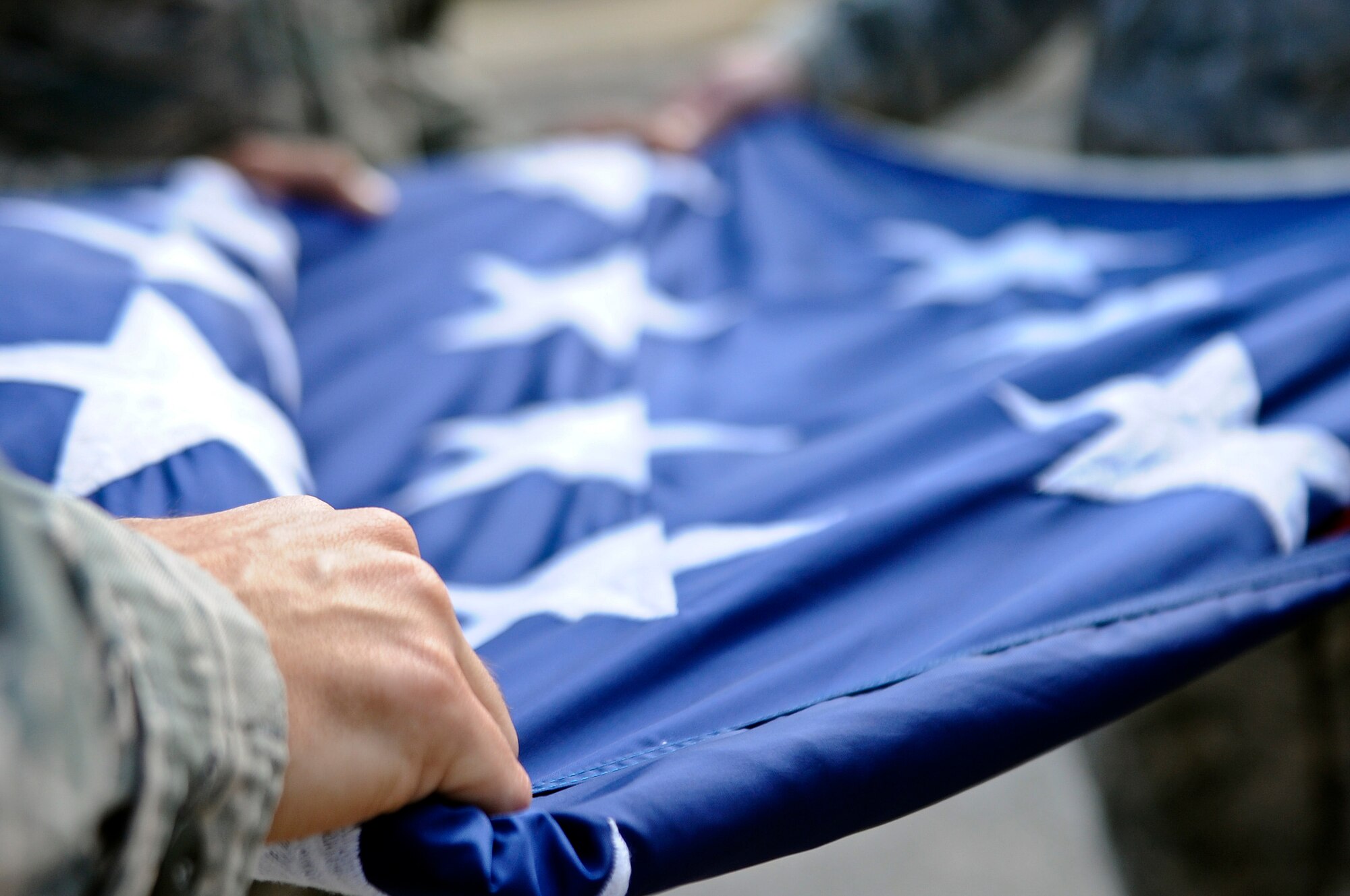 An honor guardsman folds the American flag during a retreat ceremony on Hurlburt Field, Fla., Feb. 10, 2014. Retreat marks the end of the duty day. (U.S. Air Force photo/Senior Airman Michelle Vickers)