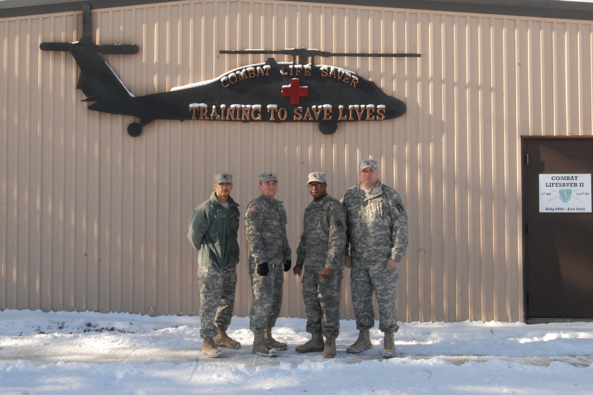 72nd Field Artillery Brigade graduates of the Combat Life Saver course Sgt. 1st Class, Kevin I. McKeithan, 2-315th Field Artillery Battalion; Sgt. 1st Class, Jesse E. Mosley, 2-315th Field Artillery Battalion; Sgt. Timothy M. Bush, 3-313th Logistics Support Battalion, and Sgt. Desmond Lanyo, 3-313th Logistics Support Battalion, pose for a class photo Jan. 24, 2014, at Joint Base McGuire-Dix-Lakehurst, N.J. The three-day course was designed to teach any Soldiers the basic medical skills needed to save lives in combat, when a Combat Medic isn't present. (U.S. Army photo by Capt. Kelvin Scott/Released)