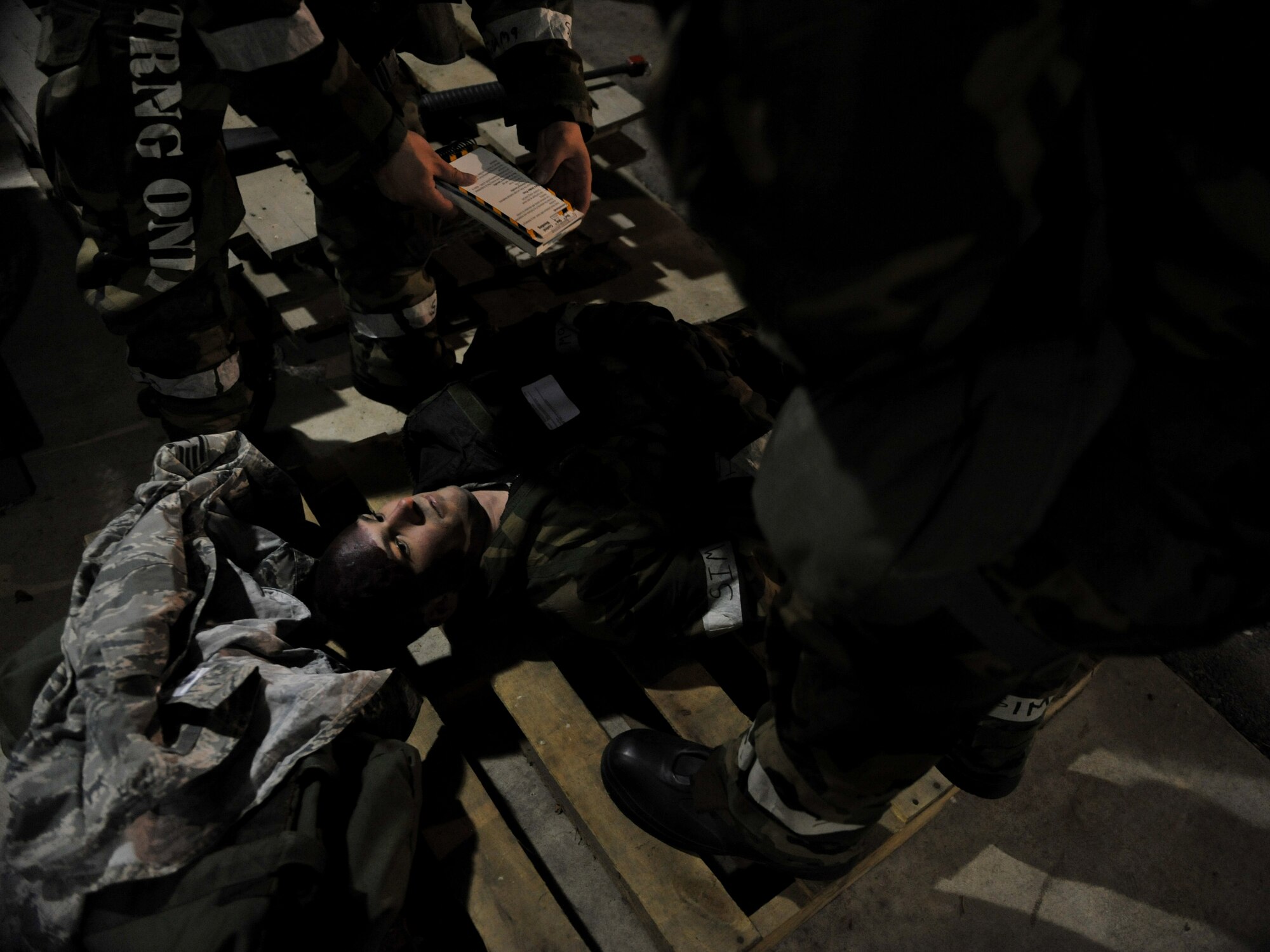 A victim of a simulated explosion awaits medical treatment by members of the 51st Logistics Readiness Squadron Traffic Management Office triage team during Beverly Midnight 14-02 at Osan Air Base, Republic of Korea, Feb. 11, 2014. Exercises like BM 14-02 test Airmen on their ability to operate and react appropriately to various war-time scenarios. (U.S. Air Force photo/Senior Airman Siuta B. Ika)