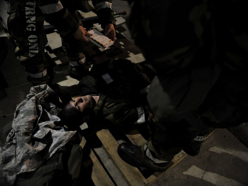 A victim of a simulated explosion awaits medical treatment by members of the 51st Logistics Readiness Squadron Traffic Management Office triage team during Beverly Midnight 14-02 at Osan Air Base, Republic of Korea, Feb. 11, 2014. Exercises like BM 14-02 test Airmen on their ability to operate and react appropriately to various war-time scenarios. (U.S. Air Force photo/Senior Airman Siuta B. Ika)