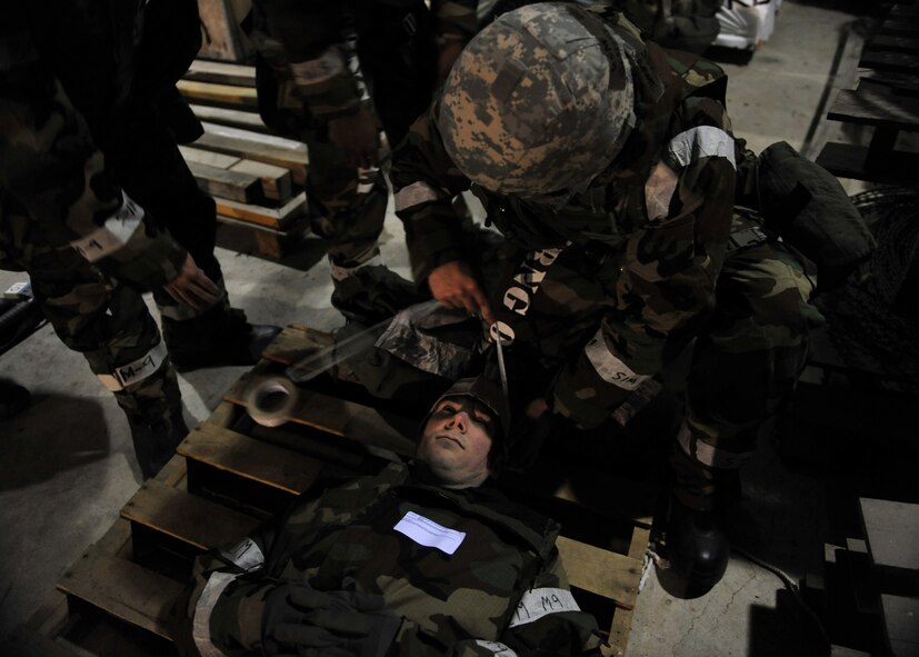 A member of the 51st Logistics Readiness Squadron Traffic Management Office triage team tends to a head wound on a simulated explosion casualty during Beverly Midnight 14-02 at Osan Air Base, Republic of Korea, Feb. 11, 2014. The triage team tended to the wounds of five different role players during this particular exercise scenario. (U.S. Air Force photo/Senior Airman Siuta B. Ika)