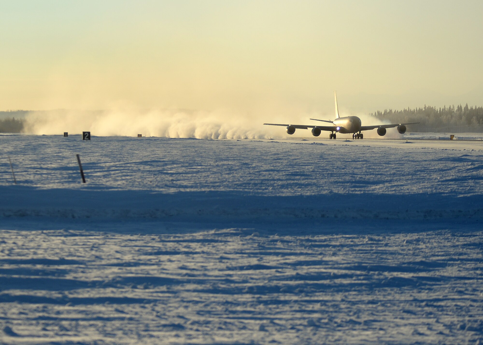 A KC-135 Stratotanker from the 22nd Air Refueling Wing, McConnell Air Force Base, Kan., takes off from Eielson Air Force Base, Alaska, Feb. 10, 2014, as an ice cloud is left behind in the almost -40 degree air. (U.S. Air Force photo by Senior Airman Shawn Nickel/Released)