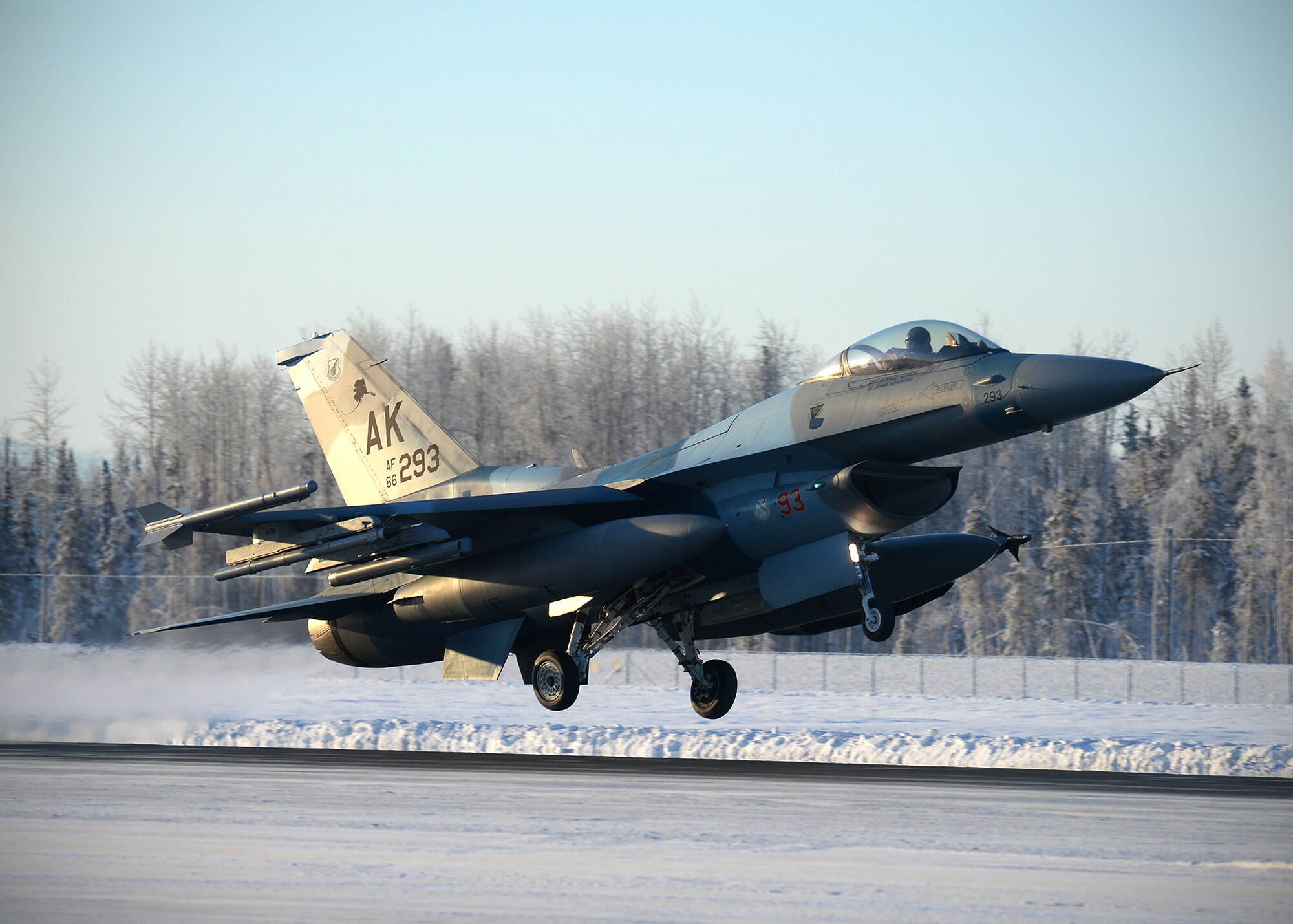 An F-16 Fighting Falcon from the 18th Aggressor Squadron takes off from Eielson Air Force Base, Alaska, Feb. 10, 2014. Ten Aggressors took off in succession to fly to Anderson Air Force Base, Guam to support Cope North, a field-training exercise hosted by Pacific Air Forces. (U.S. Air Force photo by Senior Airman Shawn Nickel/Released)