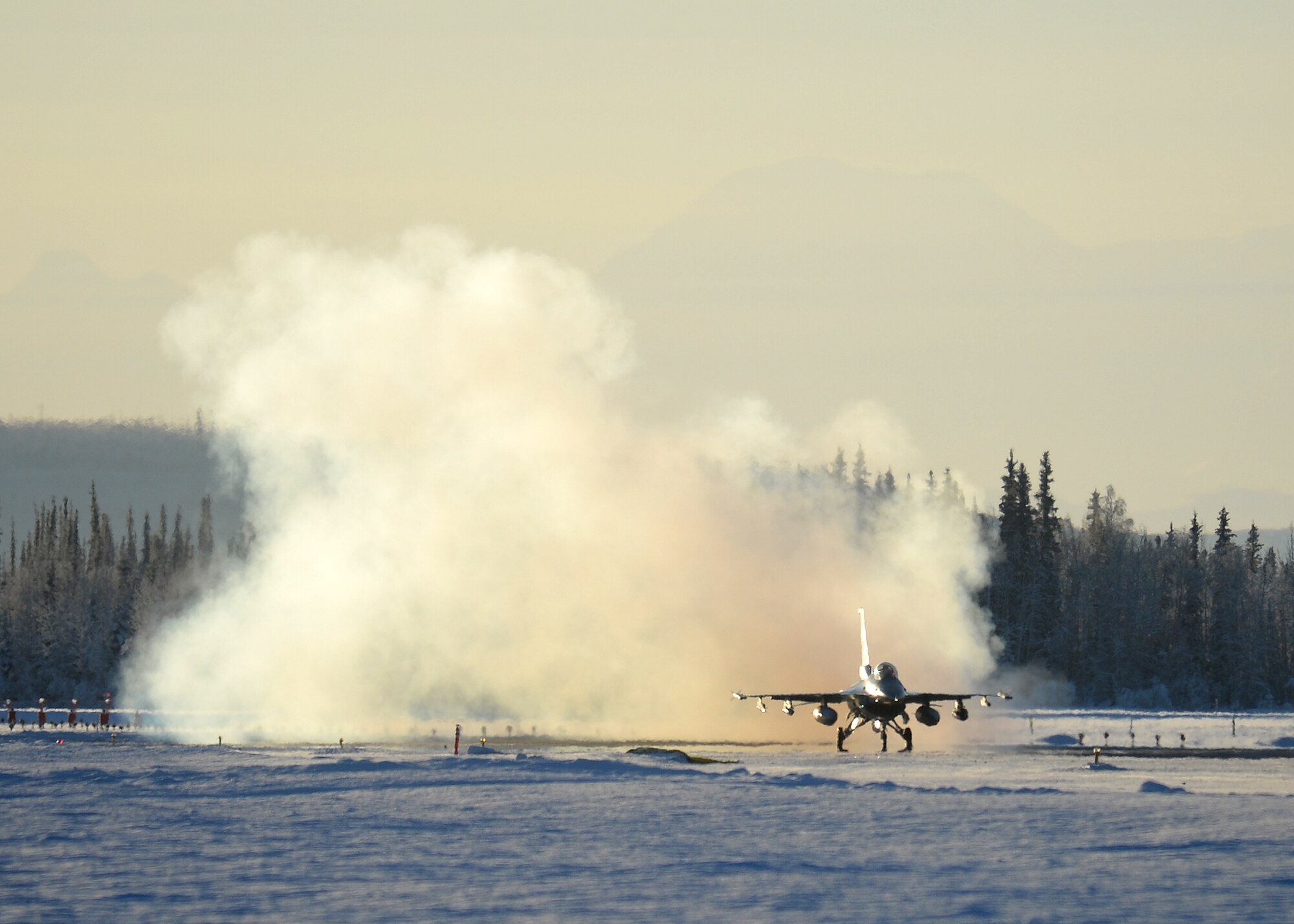 An F-16 Fighting Falcon from the 18th Aggressor Squadron takes off from Eielson Air Force Base, Alaska, Feb. 10, 2014. Ten Aggressors took off in succession to fly to Anderson Air Force Base, Guam to support Cope North, a field-training exercise hosted by Pacific Air Forces. (U.S. Air Force photo by Senior Airman Shawn Nickel/Released)