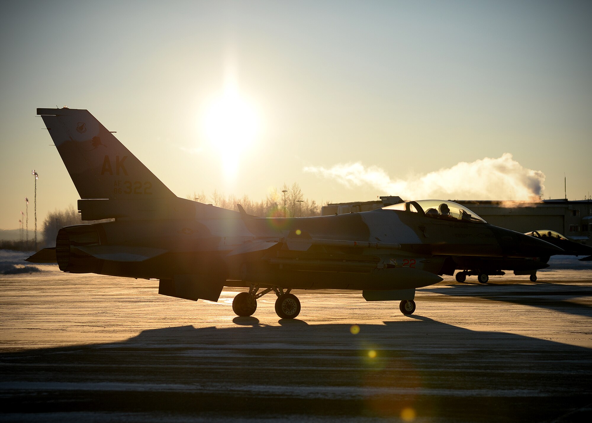 An F-16 Fighting Falcon from the 18th Aggressor Squadron prepares for takeoff from Eielson Air Force Base, Alaska, Feb. 10, 2014. Ten Aggressors took off in succession to fly to Anderson Air Force Base, Guam to support Cope North, a field-training exercise hosted by Pacific Air Forces. (U.S. Air Force photo by Senior Airman Shawn Nickel/Released) 