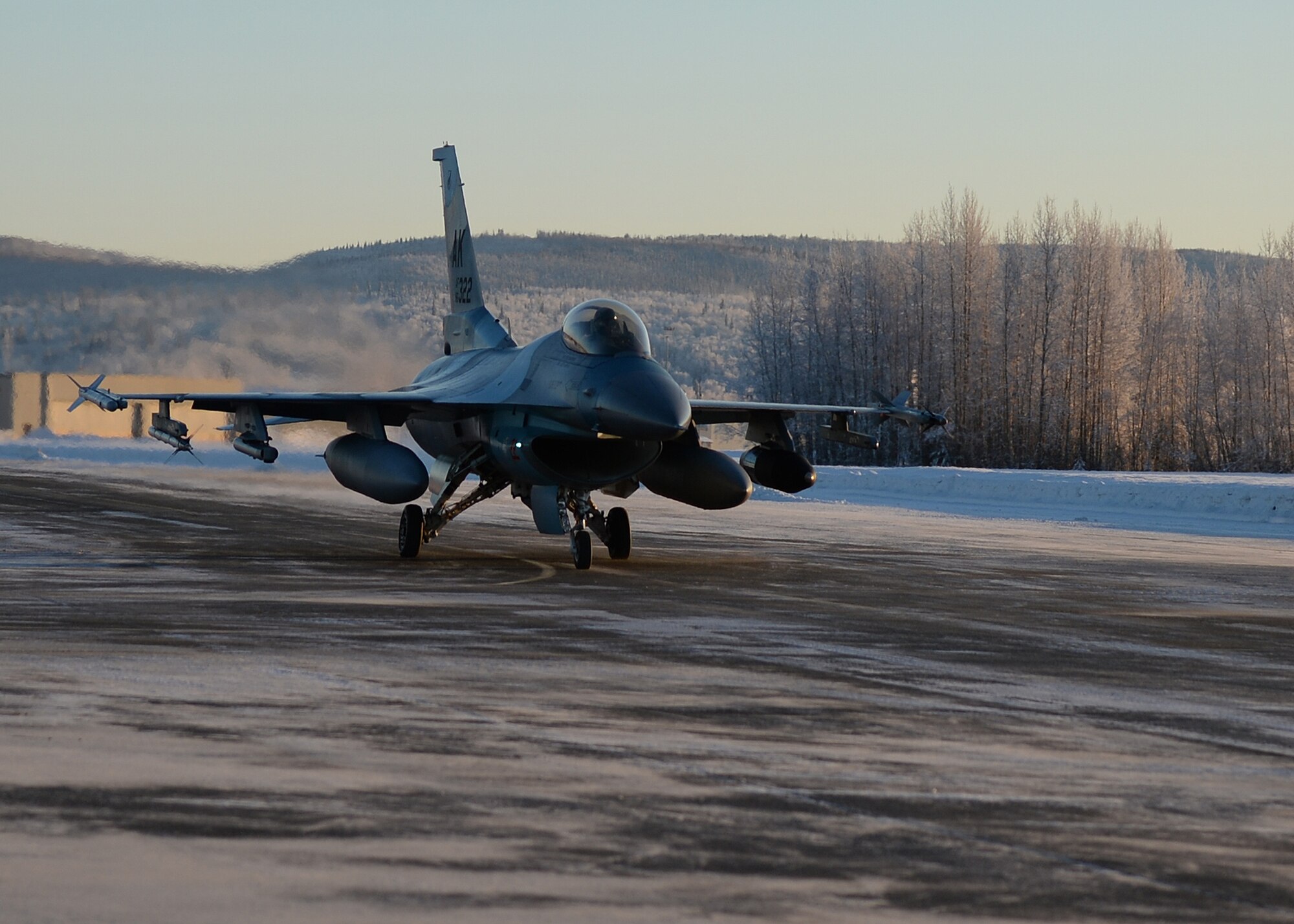 An F-16 Fighting Falcon from the 18th Aggressor Squadron prepares for takeoff from Eielson Air Force Base, Alaska, Feb. 10, 2014. Ten Aggressors took off in succession to fly to Anderson Air Force Base, Guam to support Cope North, a field-training exercise hosted by Pacific Air Forces. (U.S. Air Force photo by Senior Airman Shawn Nickel/Released) 