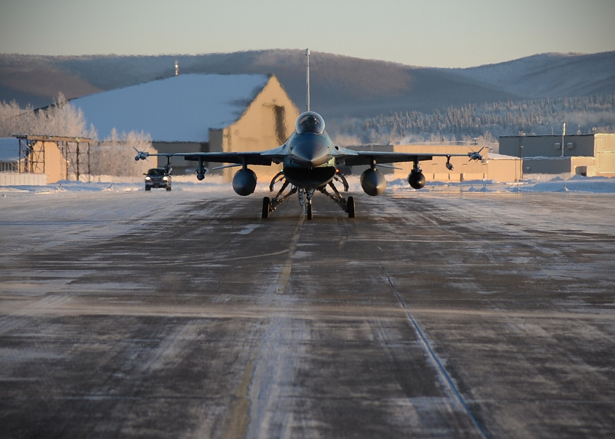An F-16 Fighting Falcon from the 18th Aggressor Squadron taxis to the flight line at Eielson Air Force Base, Alaska, Feb. 10, 2014. Ten Aggressors took off in succession to fly to Anderson Air Force Base, Guam to support Cope North, a field-training exercise hosted by Pacific Air Forces. (U.S. Air Force photo by Senior Airman Shawn Nickel/Released)