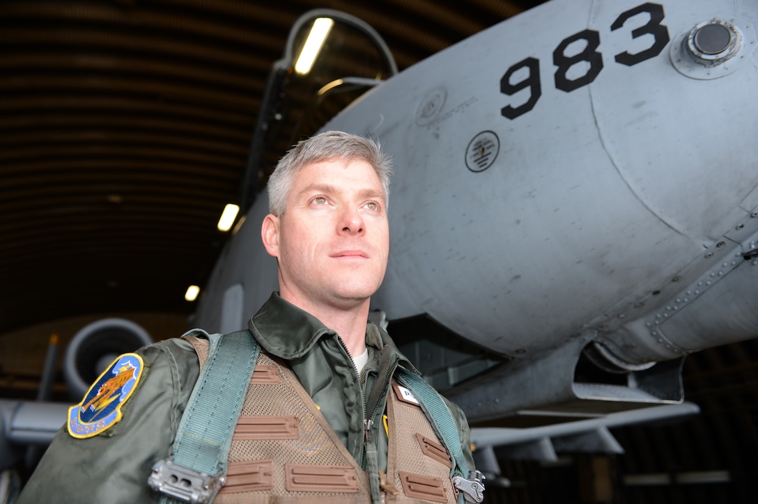 Maj. (Dr.) Jeffrey Woolford, Air Force Institute of Technology student, poses in front of an A-10 Thunderbolt II before his fini-flight Jan. 17, 2013.  A fini-flight is a military tradition celebrating a pilot’s final operational flight in an aircraft. (U.S. Air Force photo by Staff Sgt. Natasha Stannard)