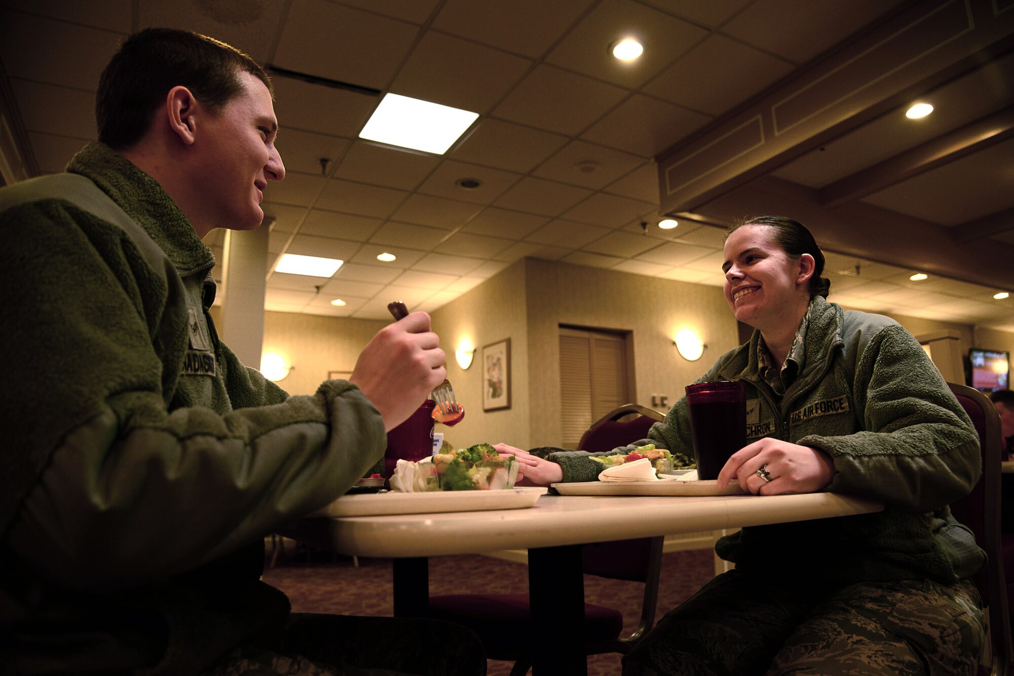 U.S. Air Force Airmen 1st Class Timothy Nadaskay, Air Combat Control Cyber Support Squadron cyber systems operations specialist, and Lindsay McEachron, 83rd Network Operations Squadron cyber systems operations specialist, eat dinner at the Crossbow dining facility at Langley Air Force Base, Va., Feb. 10, 2014. Nadaskay and McEachron met in technical training and were reunited at Langley. Nadaskay hails from Torrington, Conn. and McEachron claims Washington, D.C. as her hometown. (U.S. Air Force photo by Airman 1st Class Devin Michaels/Released)
