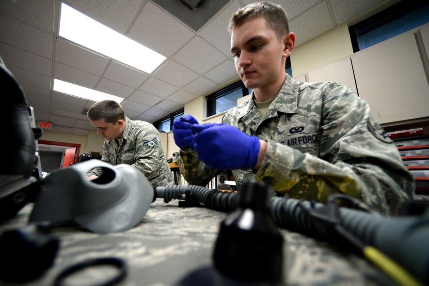 U.S. Air Force Airman 1st Class Kevin Maples, 20th Operational Support Squadron aircrew flight equipment apprentice assigned to the 77th Fighter Squadron works on an MBU-20P mask during a routine 30-day inspection, Shaw Air Force Base, S.C., Feb. 11, 2014. During an inspection of this sort, Maples checks for holes in the oxygen supply hose, ensures the batteries have a charge, and the microphones are fully functional. (U.S. Air Force photo by Airman 1st Class Jonathan Bass/Released)