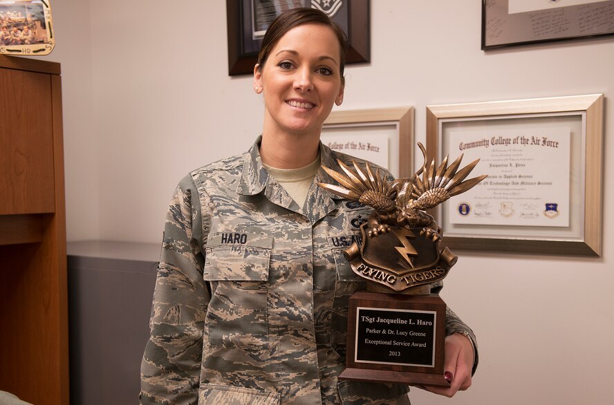 U.S. Air Force Tech. Sgt. Jacqueline Haro, 23d Maintenance Group maintenance training scheduler  holds her Parker and Dr. Lucy Greene Exceptional Service Award at Moody Air Force Base, Ga., Feb. 6, 2014. Haro, first recipient, was awarded for her demonstrated service to the base and commitment to the community. (U.S. Air Force photo by Senior Airman Tiffany M. Grigg/Released) 