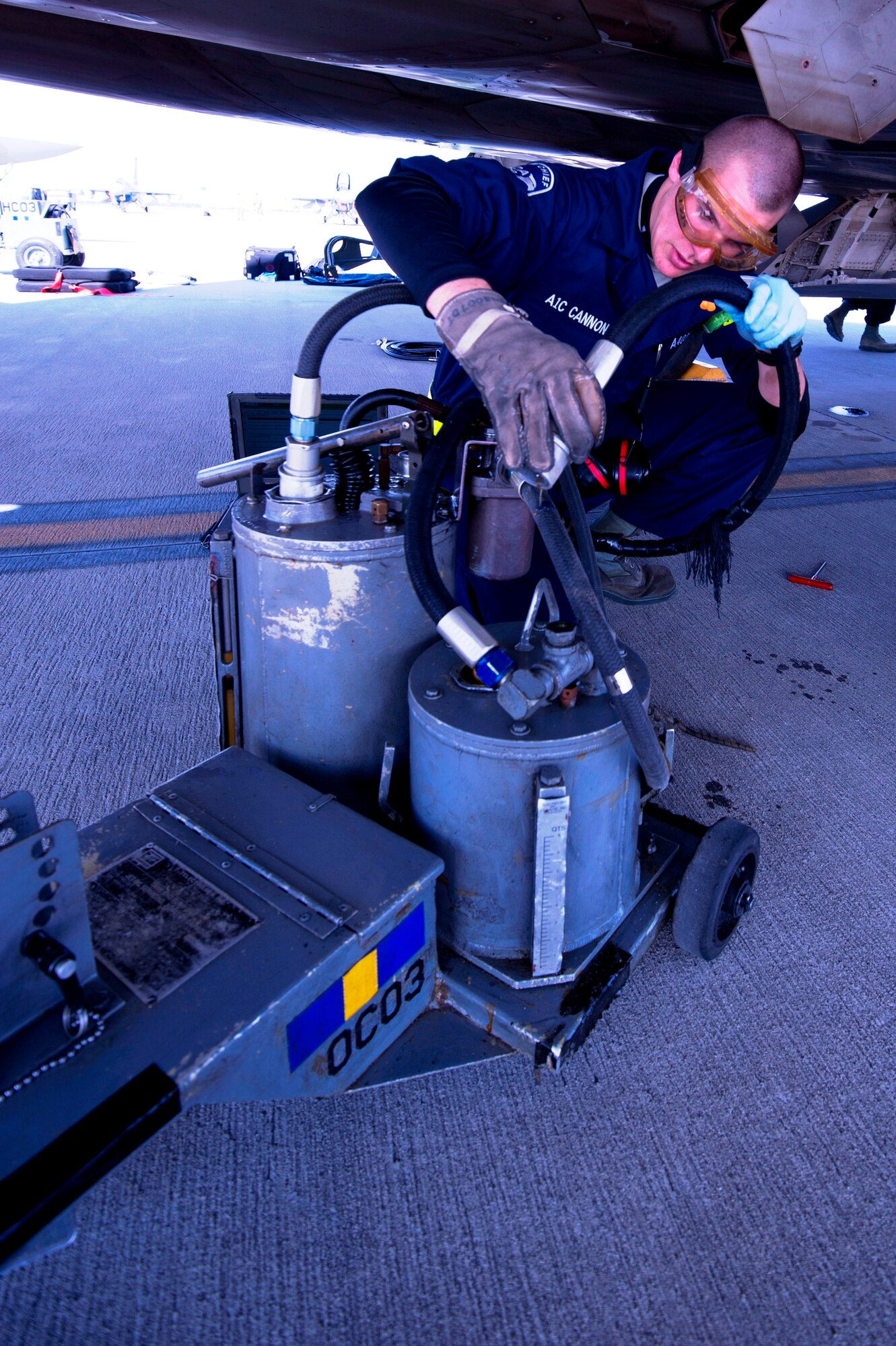 Airman 1st Class Nicholas Cannon, 43rd Aircraft Maintenance Unit crewchief, services the engine oil of an F-22 Raptor Feb. 10 at the Savannah Combat Readiness Training Center, 165th Airlift Wing, Savannah Air National Guard, Savannah, Ga. Tyndall deployed more than 200 members to Savannah for Sentry Savannah 2014, a joint-force deployment exercise. (U.S. Air Force photo by Senior Airman Christopher Reel)