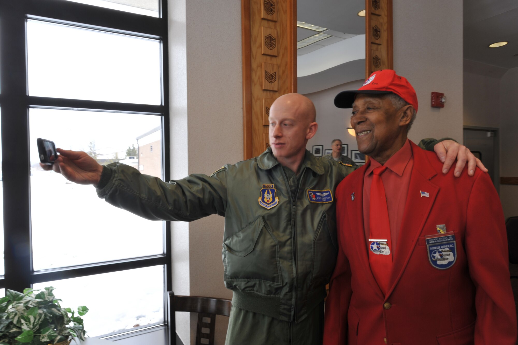 Tech. Sgt. Ryan Jackson of the 732nd Airlift Squadron at Joint Base McGuire-Dix-Lakehurst, N.J., takes a selfie with Tech. Sgt. (Ret.) George Watson Sr., an original Tuskegee Airman, Feb. 7, following a mentoring luncheon where Watson was the keynote speaker. Sponsored by the 514th Air Mobility Wing Human Resource Development Council, the event is the first of a series of mentoring luncheons the Reserve organization has planned for 2014. (U.S. Air Force photo/Master Sgt. Donna T. Jeffries) 