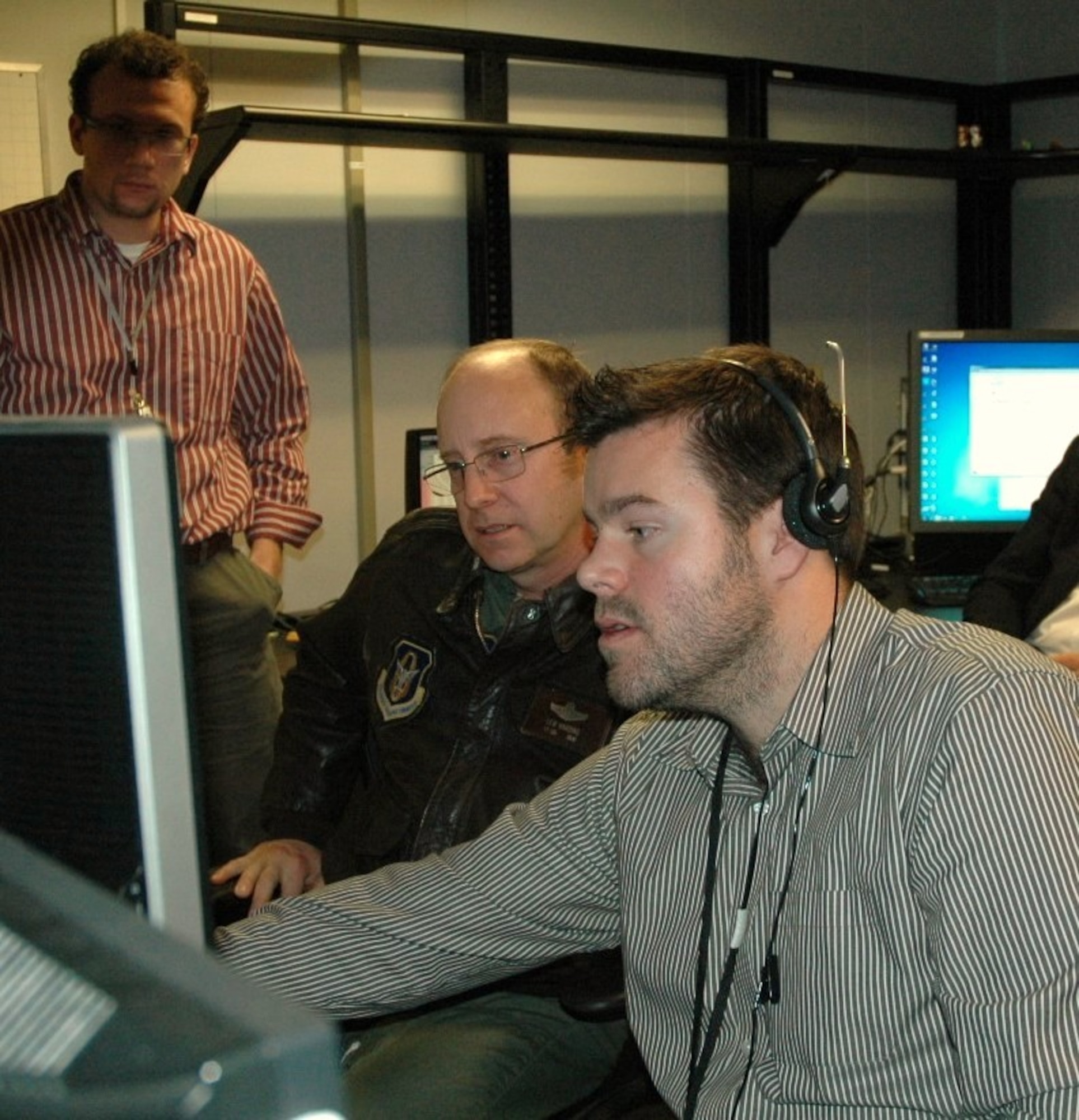Lt. Col. Lewis Harding provides feedback to engineers at the Ames Research Center, Moffett Field, Calif.  Harding, 940th Wing RQ-4 instructor pilot with the reserve wing at Beale Air Force Base, Calif., was one of several Global Hawk pilots who have volunteered to be part of the NASA’s newest research project to help the FAA establish standards and requirements as the agency sets guidelines for integrating Unmanned Aerial Systems with the National Air Space air traffic control system. (U.S. Air Force photo/Dana Lineback)