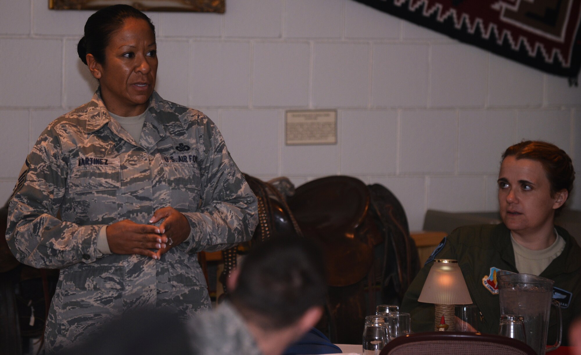 Master Sgt. Gracey Martinez, 28th Operations Support Squadron airfield manager, talks about her job and their duties while she was deployed during the Black Hill Stock Show Foundation’s Military Appreciation Luncheon in the Rushmore Plaza Civic Center at Rapid City, S.D., Feb. 4, 2014. For more than 10 years, the BHSSF has recognized 10 Airmen and 10 South Dakota National Guard Soldiers at their annual luncheon as a way of thanking them for their hard work and sacrifice. (U.S. Air Force Photo by Airman 1st Class Rebecca Imwalle/Released)
