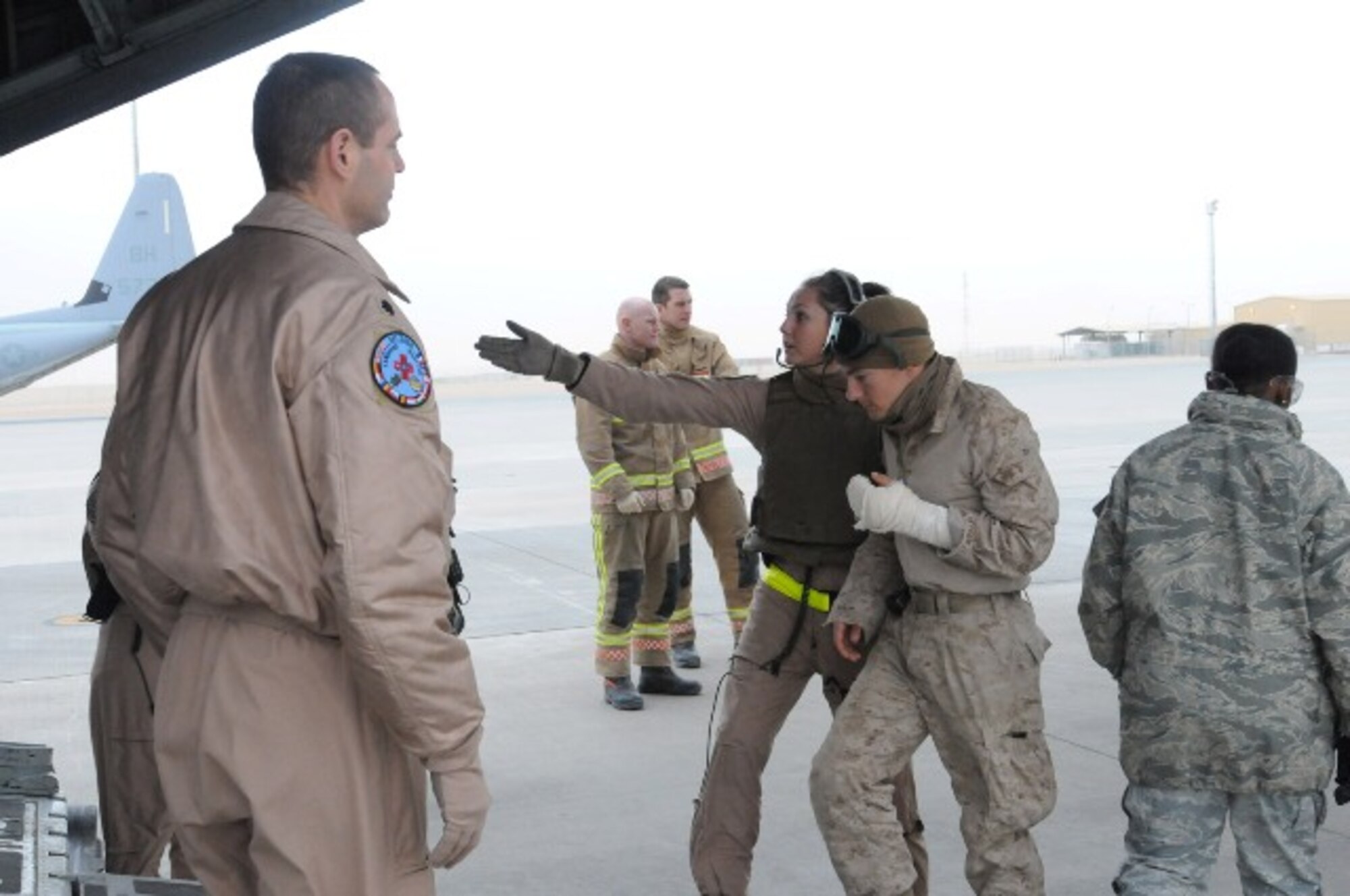 Staff Sgt. Melissa Deardorff, a flight medic with the 36th Aeromedical Evacuation Squadron, helps a wounded servicemember onto a C-130 while deployed to Afghanistan.  Deardorff has been selected to play on the U.S. Air Force Europe volleyball team for a second time.  (Courtesy photo)
