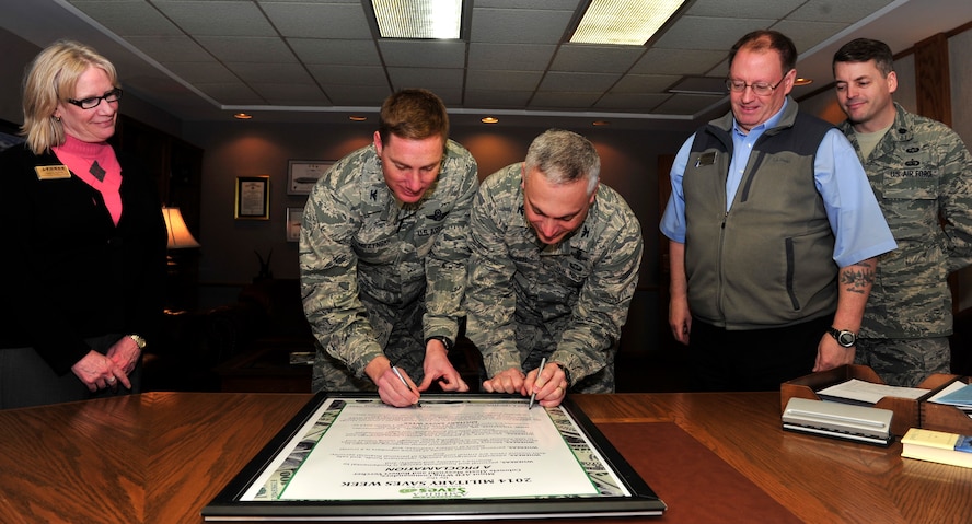 Military Saves is a social marketing campaign to persuade, motivate, and encourage military families to save money every month. Col. Alex Mezynski, 5th Bomb Wing commander and Col. Robert Vercher, 91st Missile Wing commander participate in the 2014 Military Saves Proclamation signing at Minot Air Force Base Feb. 7, 2014, to help promote financial awareness. (U.S. Air Force photo/ Senior Airman Kristoffer Kaubisch)  