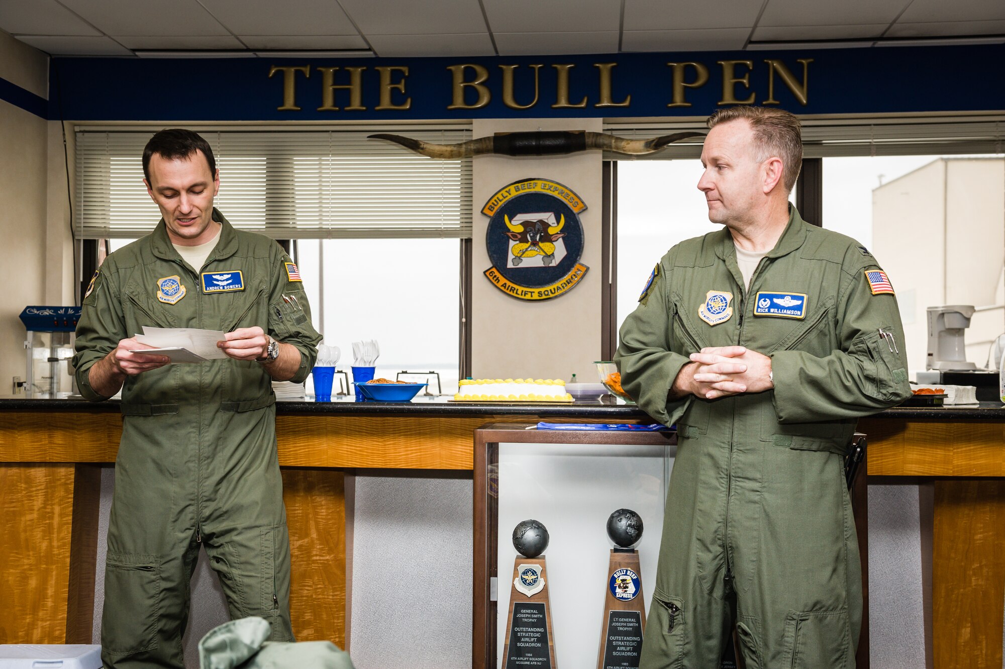 Maj. Andrew Bower, 305th Air Mobility Wing Command Action Group director, reads letters sent by senior officer and friends, congratulating Col. Richard E. Williamson Jr., 305th AMW commander, on his earning the rights of wearing the coveted aviator’s 5,000 hours flying patch. (U.S. Air Force photo by Russ Meseroll/Released)