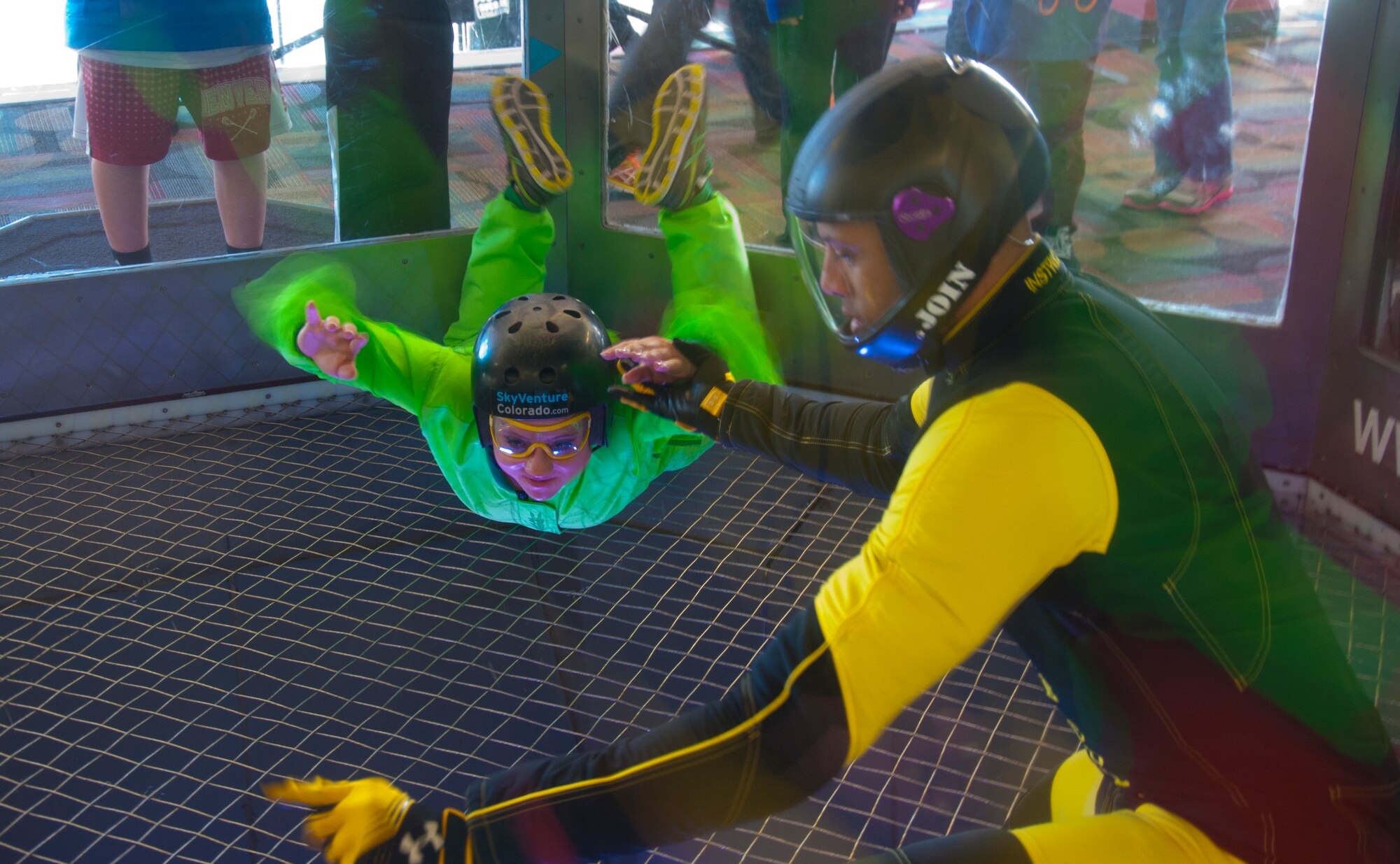 140208-F-GZ967-022 Airman 1st Class Jordan Rhodes, 90th Force Support Squadron, takes direction from Marlon Mahoney, an indoor skydiving instructor, Feb. 8 as she braves the 120 mph winds of an indoor skydiving wind tunnel. Rhodes, along with 13 other Airmen, each received more than two minutes with the instructor inside the tunnel. 