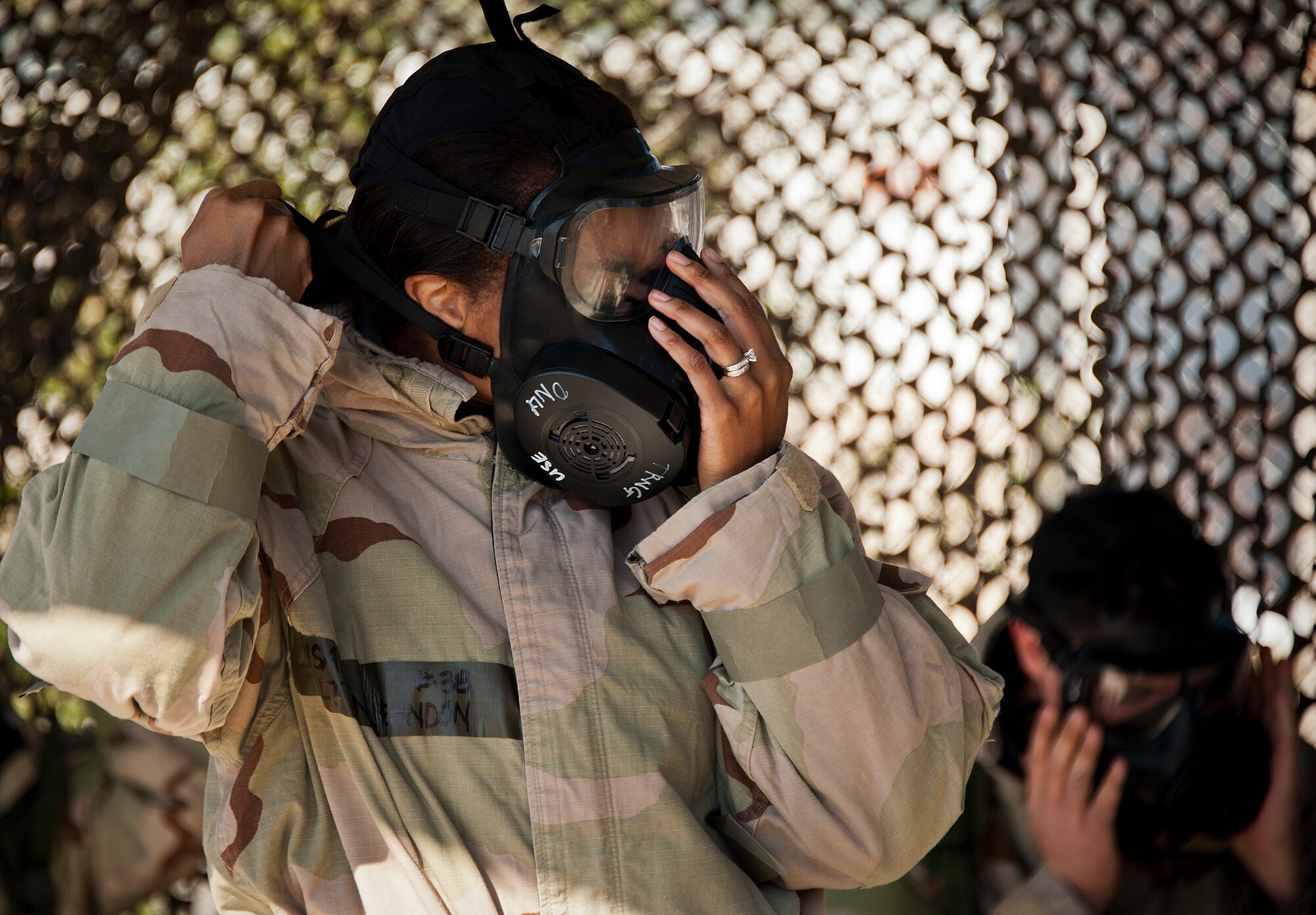 First Lt. Nicole Herndon, of the 96th Force Support Squadron, secures her gas mask after hearing the alert to go to MOPP-4 gear during the field training portion of a Phase II exercise Feb. 7 at Eglin Air Force Base, Fla. A Phase II evaluates an Airman’s ability to meet wartime and contingency taskings of employing the force, sustaining the force and the ability to survive and operate. More than 70 potential deployers received the classroom and practical field training during a series of 96th Test Wing exercises occurring all week. (U.S. Air Force photo/Sara Vidoni)