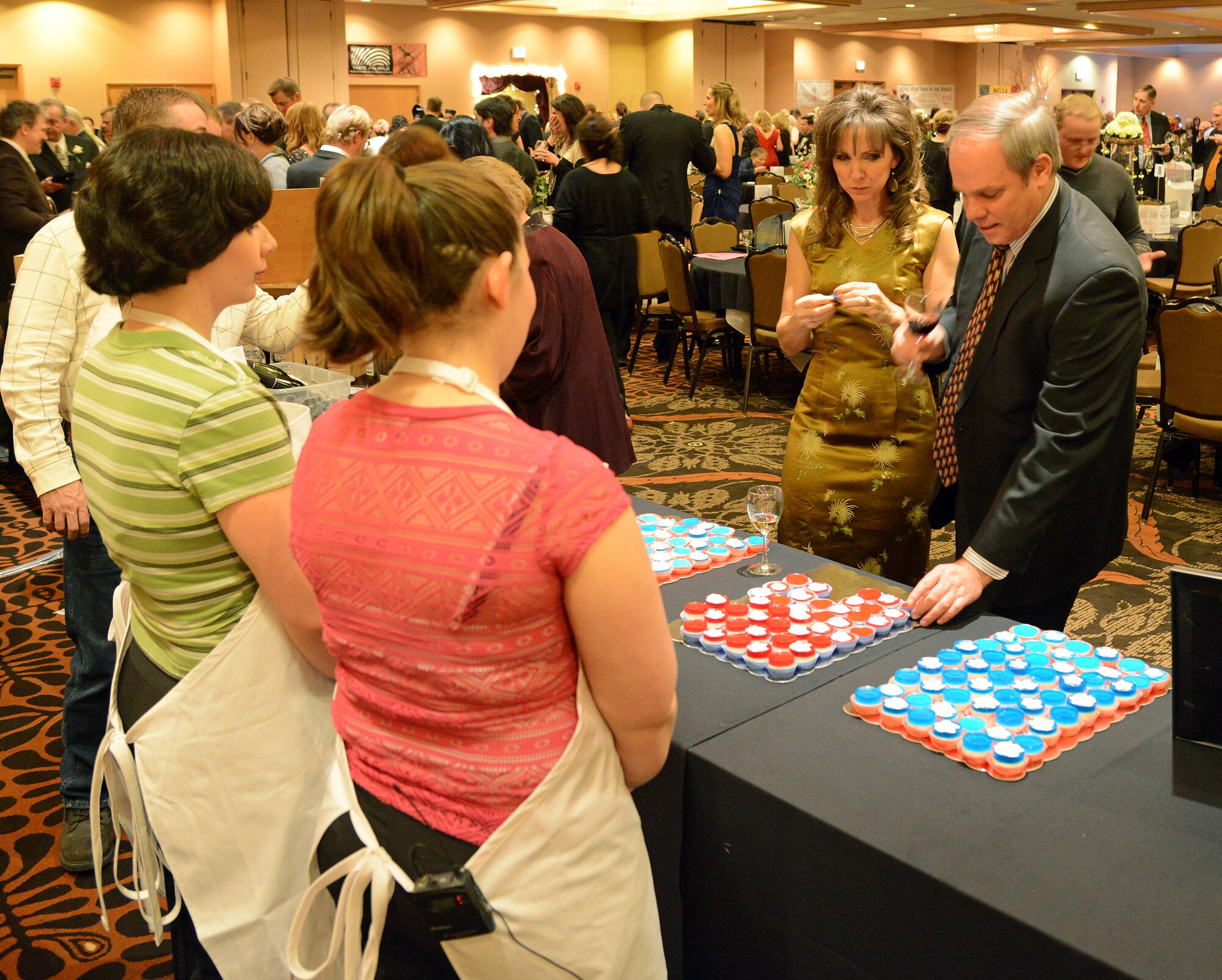 COLORADO SPRINGS, Colo. -- Guests try the Freedom Feelers at the Best of the Pikes Peak Area Chefs competition during the annual Glass Slipper Ball Jan. 25. Airman Delia Reynolds, Airman 1st Class Shayla Bohrer, Senior Airman Candace Philippo and Airman 1st Class Bridget Mitchell, formed the Aragon Dining Facility team that entered the annual competition. (U.S. Air Force photo/Tech. Sgt. Jared Marquis)