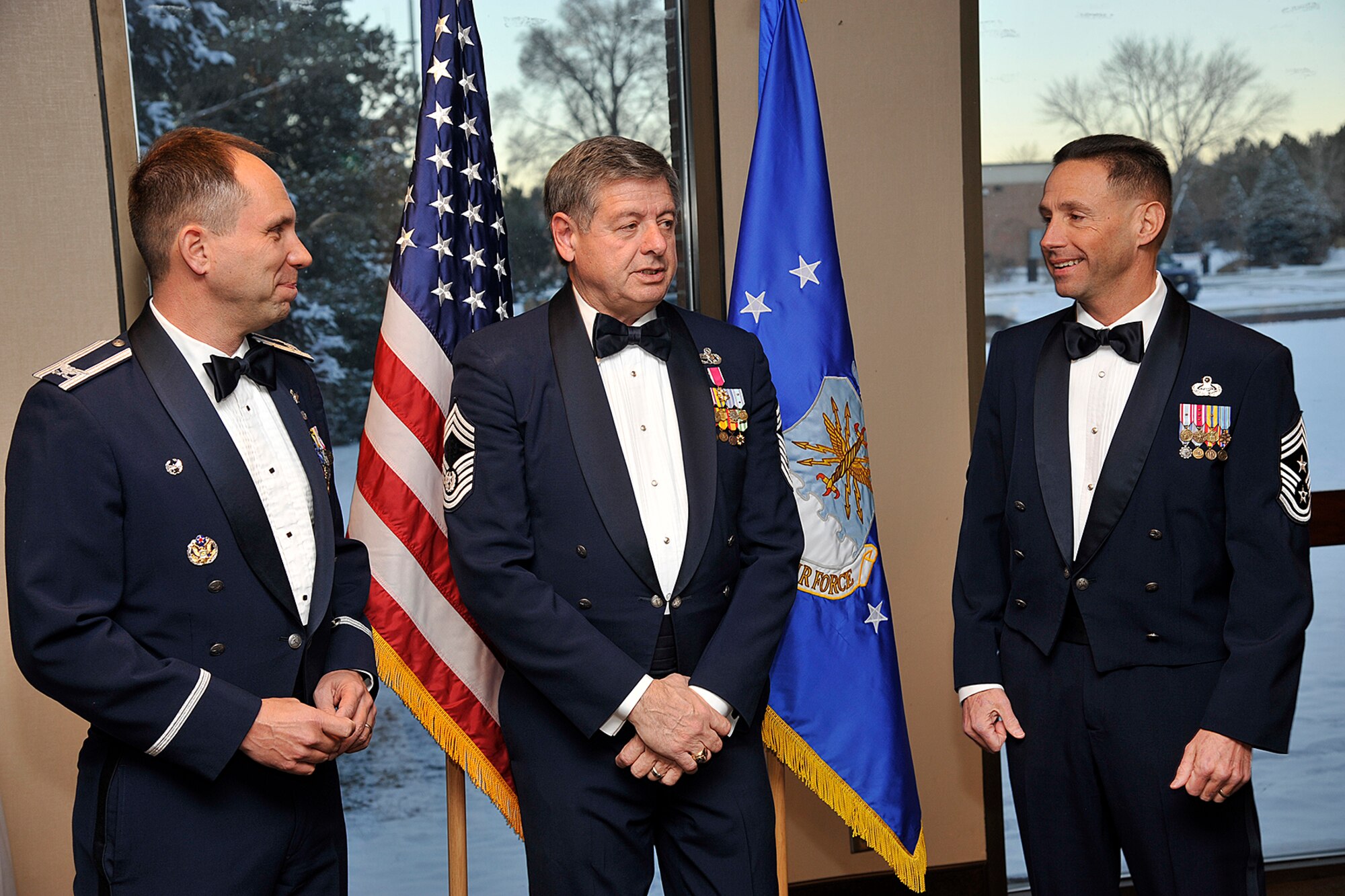 PETERSON AIR FORCE BASE, Colo. – (Left to right) Col. John Shaw, 21st Space Wing commander, former Chief Master Sgt. of the Air Force David Campanale, the 11th chief master sergeant of the Air Force, and Chief Master Sgt. Richard Redman talk before the annual award dinner Jan. 28. While Campanale was here, he visited the Airmen Leadership School and the Vosler NCO Academy to speak on past experiences pertaining to the future of the Air Force. (U.S. Air Force photo/Dennis Howk) 