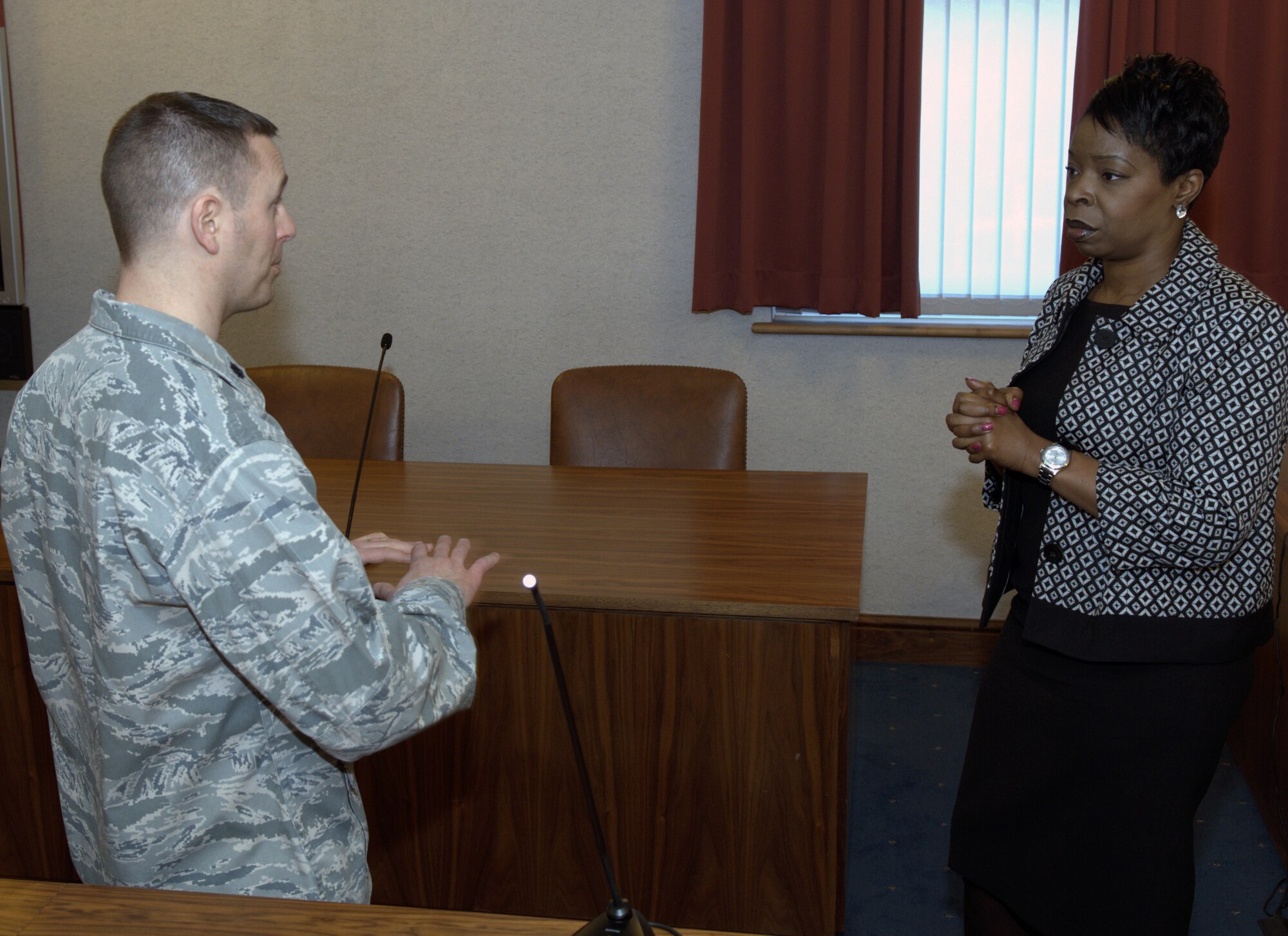 Grace Ononiwu, right, East of England Chief Crown Prosecutor, meets with U.S. Air Force Lt. Col. Seth Deam, 100th Air Refueling Wing Staff Judge Advocate, Feb. 2, 2014, on RAF Mildenhall, England. Ononiwu visited with the RAF Mildenhall Judge Advocate office to gain a better understanding of the U.S. military justice system. Deam explained U.S. military court procedures to Ononiwu while touring the base courtroom. (U.S. Air Force photo by Airman 1st Class Jonathan Light/Released)