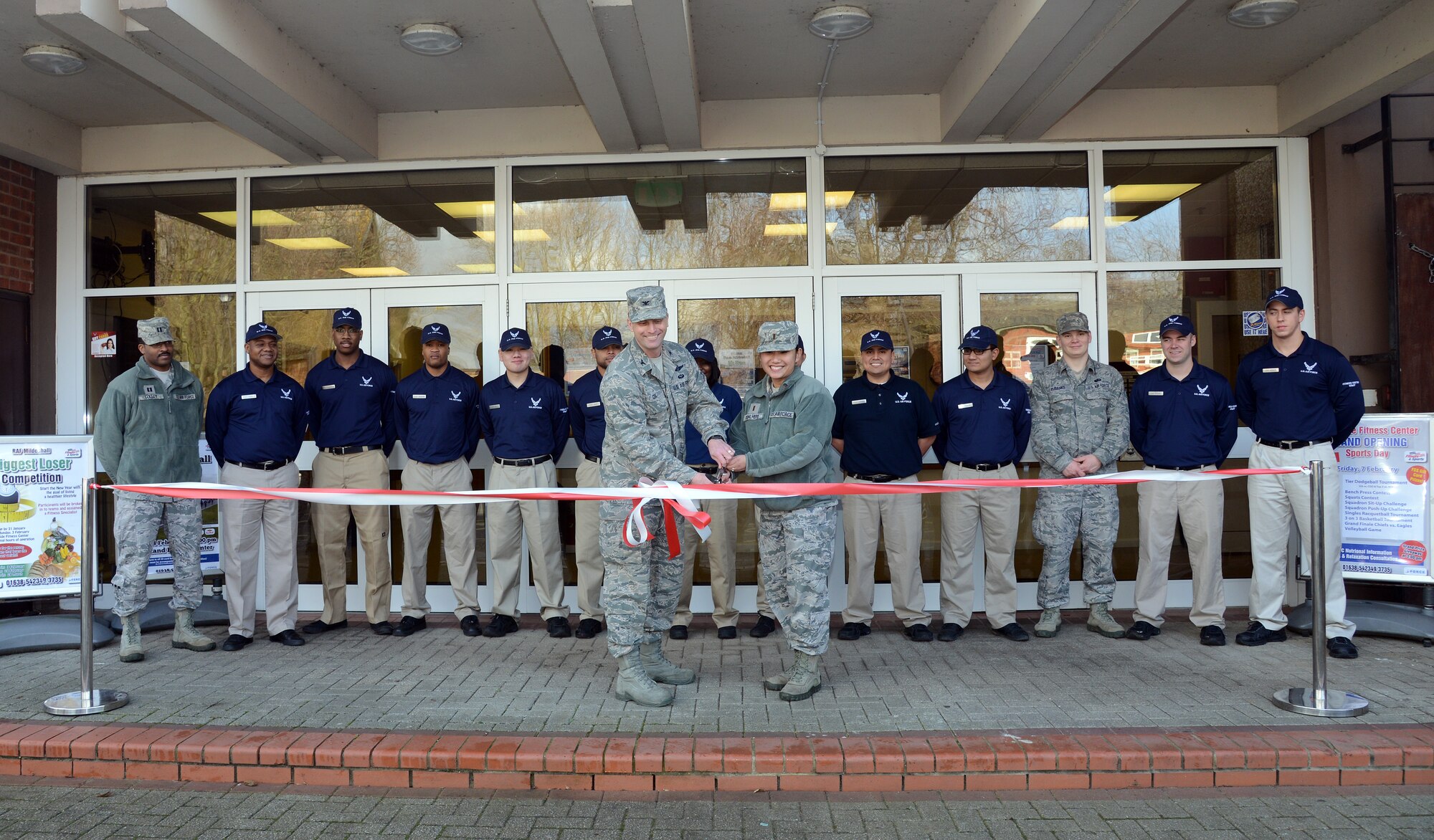U.S. Air Force Col. David Cox, 100th Air Refueling Wing vice commander, and U.S. Air Force 2nd Lt. Joanna Kohlhepp, 100th Force Support Squadron fitness flight chief, cut a ribbon reopening the Northside Fitness Center Feb. 2, 2014, on RAF Mildenhall, England. The center closed for remodeling in November 2013. The grand reopening of the center was on Feb. 7, 2014. (U.S. Air Force photo by Airman 1st Class Kelsey Waters/Released)