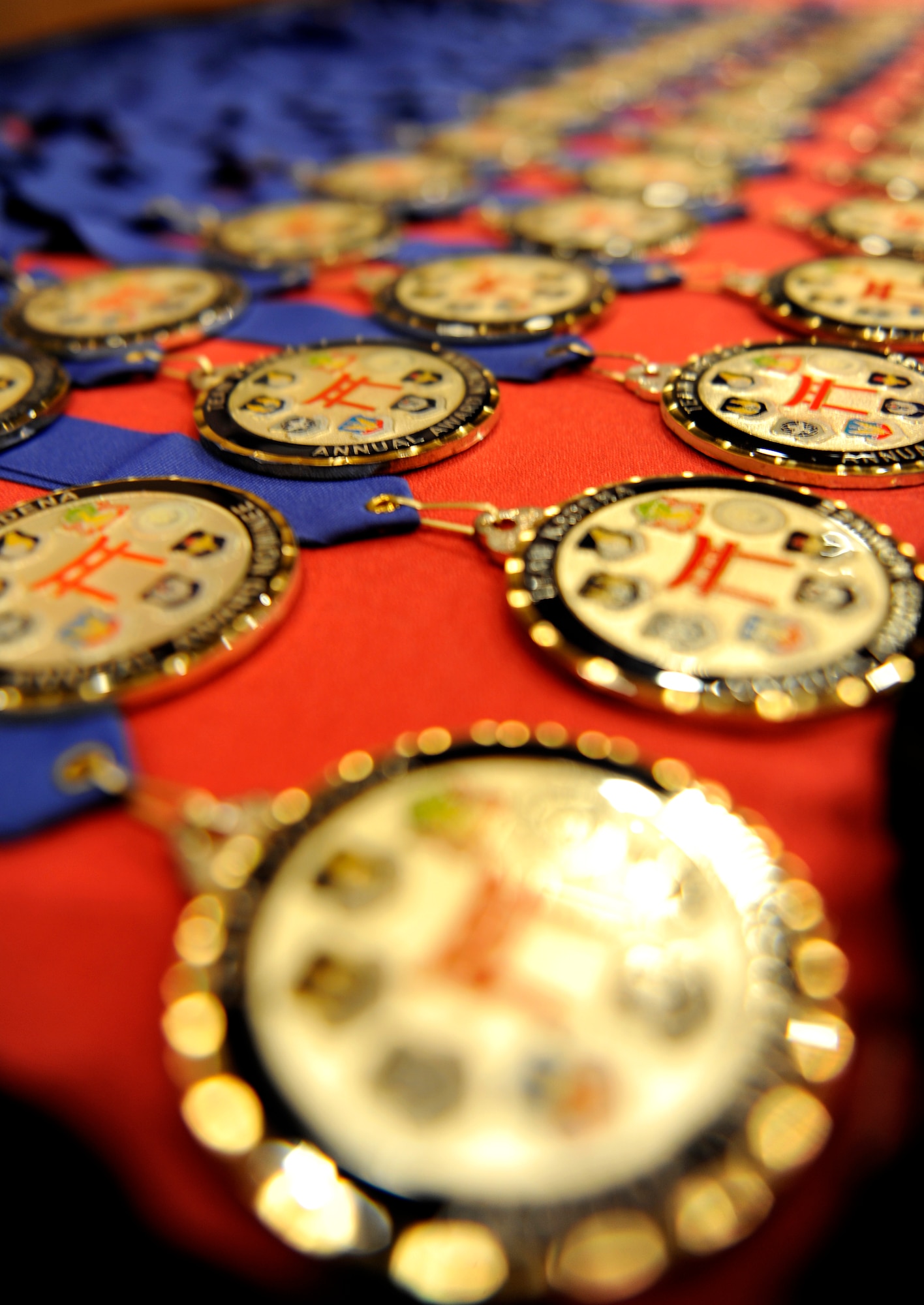 2013 18th Wing/Partner Unit and Team Kadena award nomination medals are arranged on a table to be given to nominees preceding the awards banquet at the Rocker NCO Club on Kadena Air Base, Japan, Feb. 8, 2014. During the banquet, 18 winners were chosen from 11 different organizational groups and the Kadena Honor Guard as the top performers of 2013. (U.S. Air Force photo by Senior Airman Maeson L. Elleman)