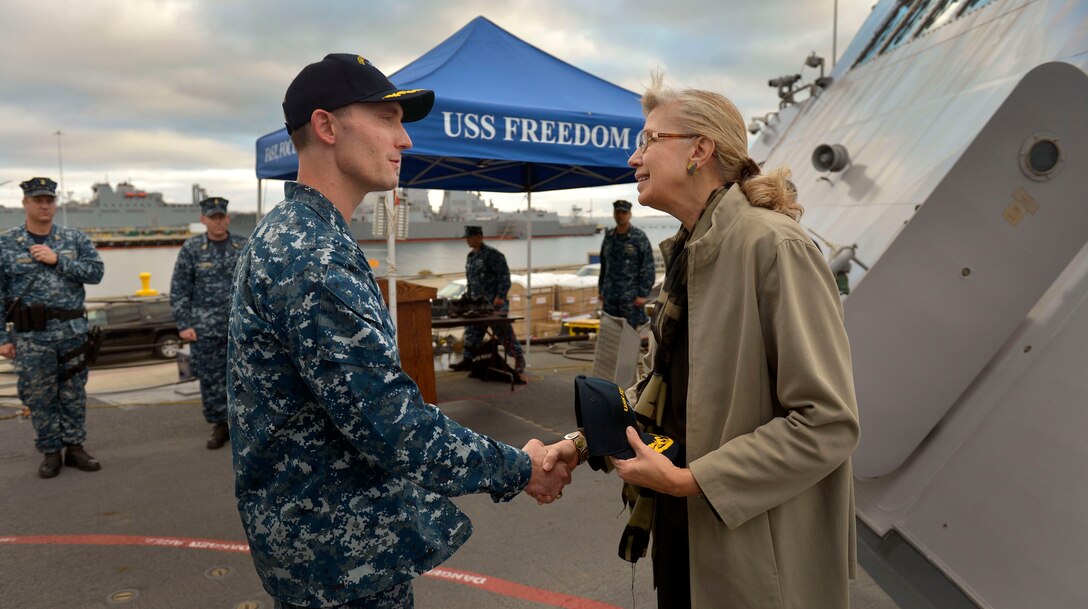 Acting Deputy Defense Secretary Christine H. Fox listens as Navy Cmdr. Michael R. Jarrett Jr., commanding officer of the USS Freedom, gives her a tour of the ship in San Diego, Feb. 10, 2014. 