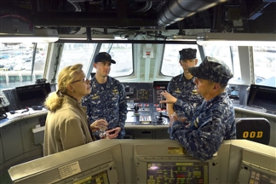 Acting Deputy Defense Secretary Christine H. Fox and Navy Vice Adm. Tom Copeman discuss technical aspects of the USS Freedom while touring the ship's bridge during her visit to San Diego, Feb. 10, 2014. Copeman is the commander of Naval Surface Forces, Naval Surface Force, U.S. Pacific Fleet. Fox, who is on a two-day trip, visited Fort Riley, Kan., earlier in the day to observe training and tactical operations.