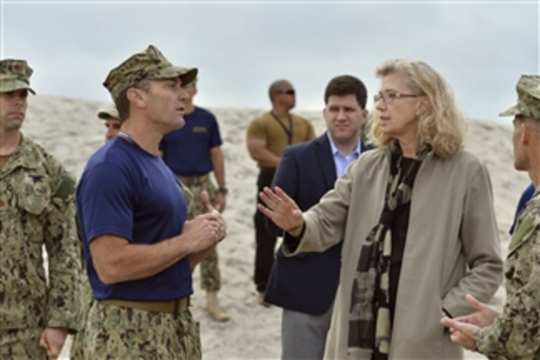 Acting Deputy Defense Secretary Christine H. Fox gets a briefing from Navy Master Chief Petty Officer Paul Baden as she tours SEAL Beach, named after the Navy's special operations force, at the Navy Special Warfare Center in San Diego, Feb. 10, 2014. Fox, who is on a two-day trip, visited Fort Riley, Kan., earlier in the day to observe training and tactical operations.