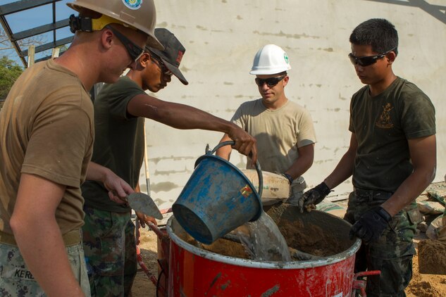 A U.S. sailor, airman and Royal Thai Marines mix wall plaster Feb. 10 at Wut Khun Song school near Ban Chan Krem, Kingdom of Thailand. The service members joined forces for a community relations project in which three new classrooms were built. The community relations project started Jan. 25 and is expected to be completed Feb. 20. The program is part of Exercise Cobra Gold 2014, a multinational and multiservice exercise that takes place annually in the Kingdom of Thailand and was developed by the Thai and U.S. militaries. The Royal Thai Marines are combat engineers with Combat Engineer Battalion, 3rd Royal Thai Marine Division. The U.S. sailors are with the Seabees’ Naval Mobile Construction Battalion 3, 1st Naval Construction Group.