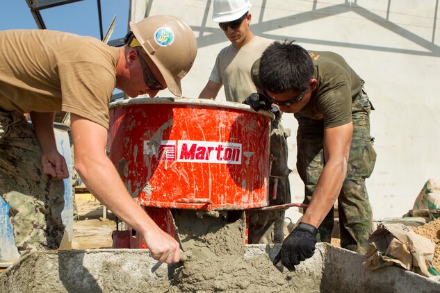 U.S. Navy Petty Officer 3rd Class Ethan P. Kerber, left, U.S. Air Force Senior Airman Carlos E. Flores, center, and Royal Thai Petty Officer 2nd Class Tam Wanchai prepare wall plaster Feb. 10 at a Wut Khun Song school near Ban Chan Krem, Kingdom of Thailand. The service members joined forces for a community relations project in which three new classrooms were built. The community relations project started Jan. 25 and is expected to be completed Feb. 20. The program is part of Exercise Cobra Gold 2014, which is a multinational and multiservice exercise that takes place annually in the Kingdom of Thailand and was developed by the Thai and U.S. militaries. Wanchai is a combat engineers with Combat Engineer Battalion, 3rd Royal Thai Marine Division the Kerber is a steelworker with the Seabees’ Naval Mobile Construction Battalion 3, 1st Naval Construction Group and Flores is an electrical power production journeyman with 35th Civil Engineer Squadron, 35th Fighter Wing.