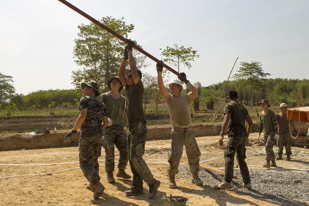 U.S. service members, Royal Thai Marines and Republic of Korea Marines work together to lift a piece of roofing material Feb. 10 Wut Khun Song school near Ban Chan Krem, Kingdom of Thailand. The material will serve as the base to the rest of the roof when the school is completed. The community relations project started Jan. 25 and is expected to be completed Feb. 20. The program is part of Exercise Cobra Gold 2014, which is a multinational and multiservice exercise that takes place annually in the Kingdom of Thailand and was developed by the Thai and U.S. militaries. The Royal Thai Marines are combat engineers with Combat Engineer Battalion, 3rd Royal Thai Marine Division the U.S. service members are with the Seabees’ Naval Mobile Construction Battalion 3, 1st Naval Construction Group.
