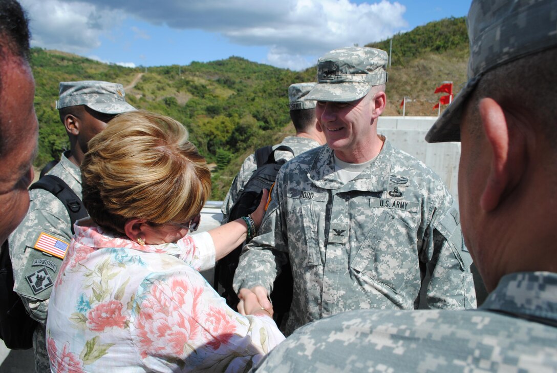 Jacksonville District Commander Col. Alan Dodd receives congratulations from the mayor of Ponce, Puerto Rico, Maria Eloisa Melendez Altieri following a dedication ceremony held at Portugues Dam Feb. 5.  The $386 million dam is expected to help reduce impacts from flooding for 40,000 people living in and around Ponce.
