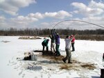University of Vermont students are core sampling on frozen Lily Pad Pond at Camp Johnson. The goal is to reach below six inches of ice, 10-12 feet of water and into a 30-foot thick layer of peat bog. In this peat bog they have found pollen spores and remnants of plants dating back over 10,000 years.