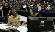 Sgt. Maj. Johnnie Hughes, Recruiting Station Kansas City sergeant major, and Mick Shaffer, a Kansas City Time Warner Cable Sports Channel on-air sports anchor, discuss many of the similarities between being a member of a basketball team and that of the Marine Corps during the Time Warner Cable Sports Channel Showcase at the Sprint Center here Jan. 20, 2014. Several male and female high school basketball teams from the greater Kansas City metropolitan area, such as the Wyandotte High School Bulldogs, Central Academy of Excellence Eagles and Raytown South High School Cardinals, competed in the showcase. 