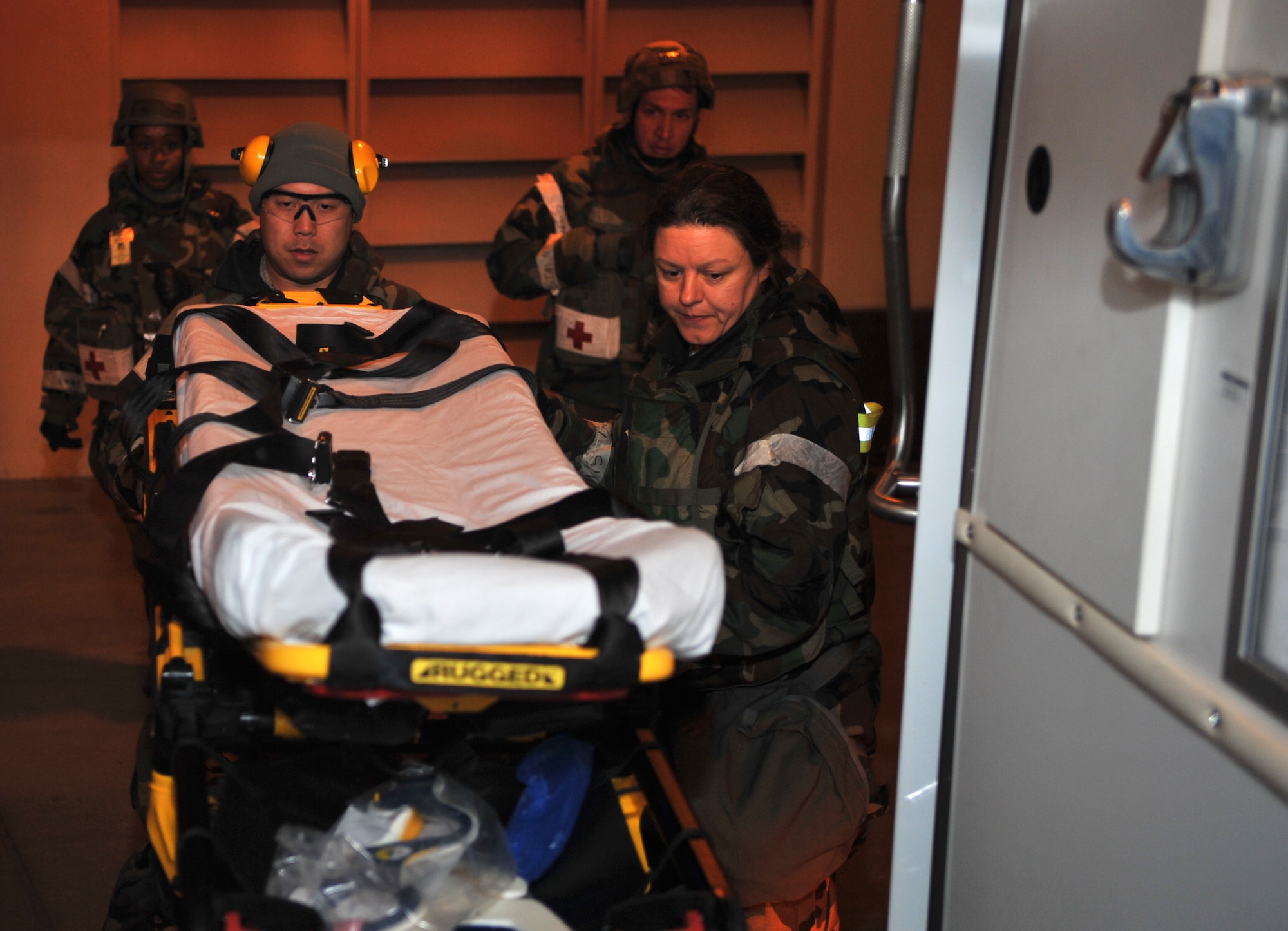 Capt. Peter Lee, 51st Dental Squadron general dentist, and Tech. Sgt. Kimberly Cruickshank, 51st Aerospace Medicine Squadron flight medicine NCO in charge, place a gurney into an ambulance after delivering two mock casualties to the 51st Medical Group Emergency Room during a medevac and dust-off scenario as part of Operational Readiness Exercise Beverly Midnight 14-02 at Osan Air Base, Republic of Korea, Feb. 12, 2014. The two were part of a four-person team that completed three trips to and from the flight line delivering five mock victims of a simulated ground engagement to the ER for advanced medical treatment. (U.S. Air Force photo/Airman 1st Class Ashley J. Thum)