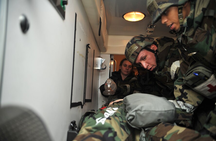 Airmen from the 51st Medical Group prepare to roll a mock casualty onto a litter for transport into the 51st MDG Emergency Room while Staff Sgt. Rebecca Lozano, 51st AMDS independent duty medical technician, continues to ventilate him with a bag valve mask during a medevac and dust-off scenario as part of Operational Readiness Exercise Beverly Midnight 14-02 at Osan Air Base, Republic of Korea, Feb. 12, 2014. In real-world operations, medevac units must sometimes “scoop and run,” requiring medical personnel receiving the casualty to further stabilize the victim in order to safely carry them into the hospital. (U.S. Air Force photo/Airman 1st Class Ashley J. Thum)