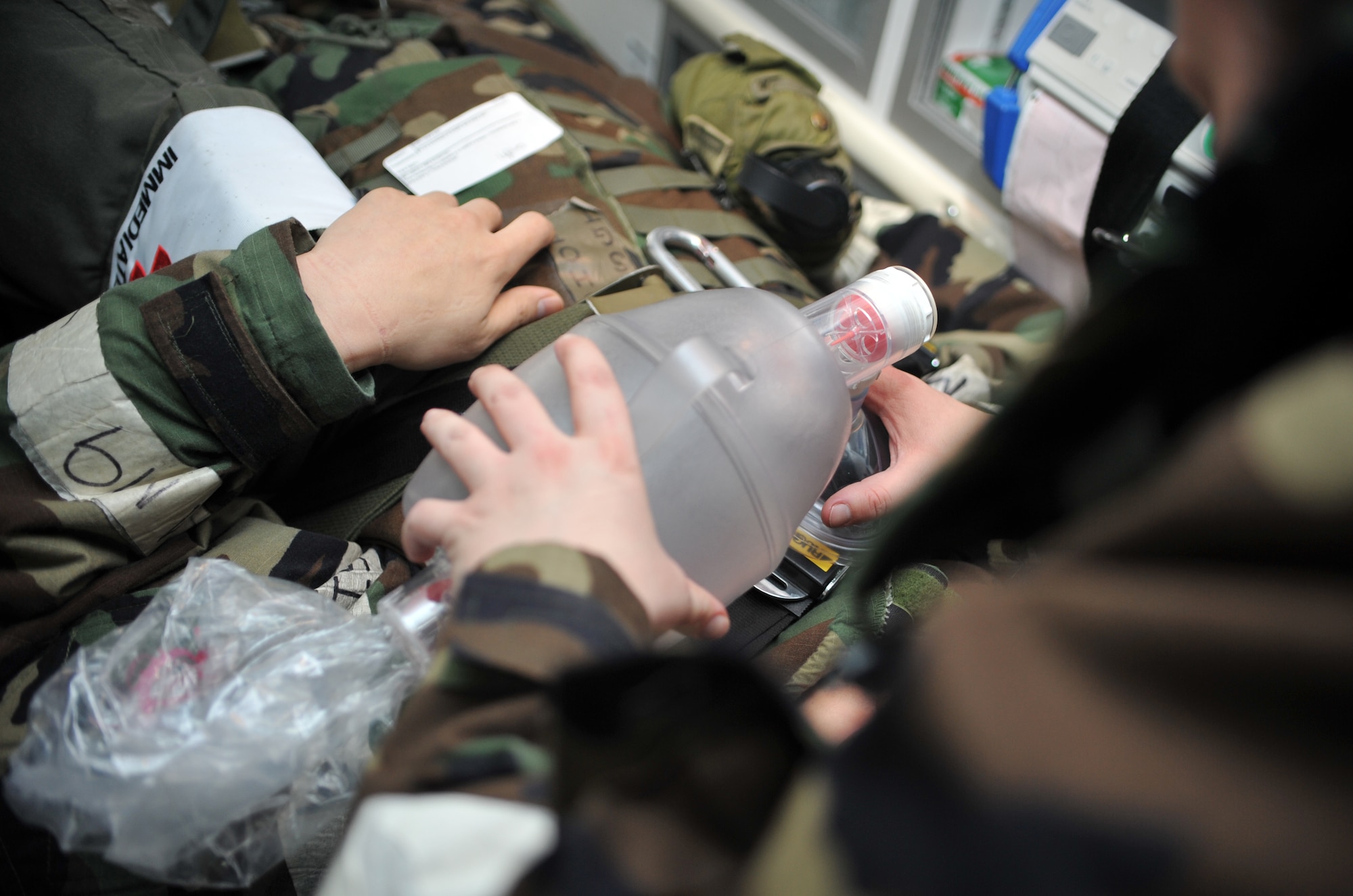 Tech. Sgt. Danielle Lantz, 51st Aerospace Medicine Squadron independent duty medical technician, ventilates a mock casualty using a bag valve mask during a medevac and dust-off scenario as part of Operational Readiness Exercise Beverly Midnight 14-02 at Osan Air Base, Republic of Korea, Feb. 12, 2014. Lantz, along with Staff Sgt. Rebecca Lozano, 51st AMDS independent duty medical technician, monitored the condition of two role players acting as casualties from a ground engagement and helped stabilize them on the way to the 51st Medical Group for further medical treatment during this segment of the scenario. (U.S. Air Force photo/Airman 1st Class Ashley J. Thum)