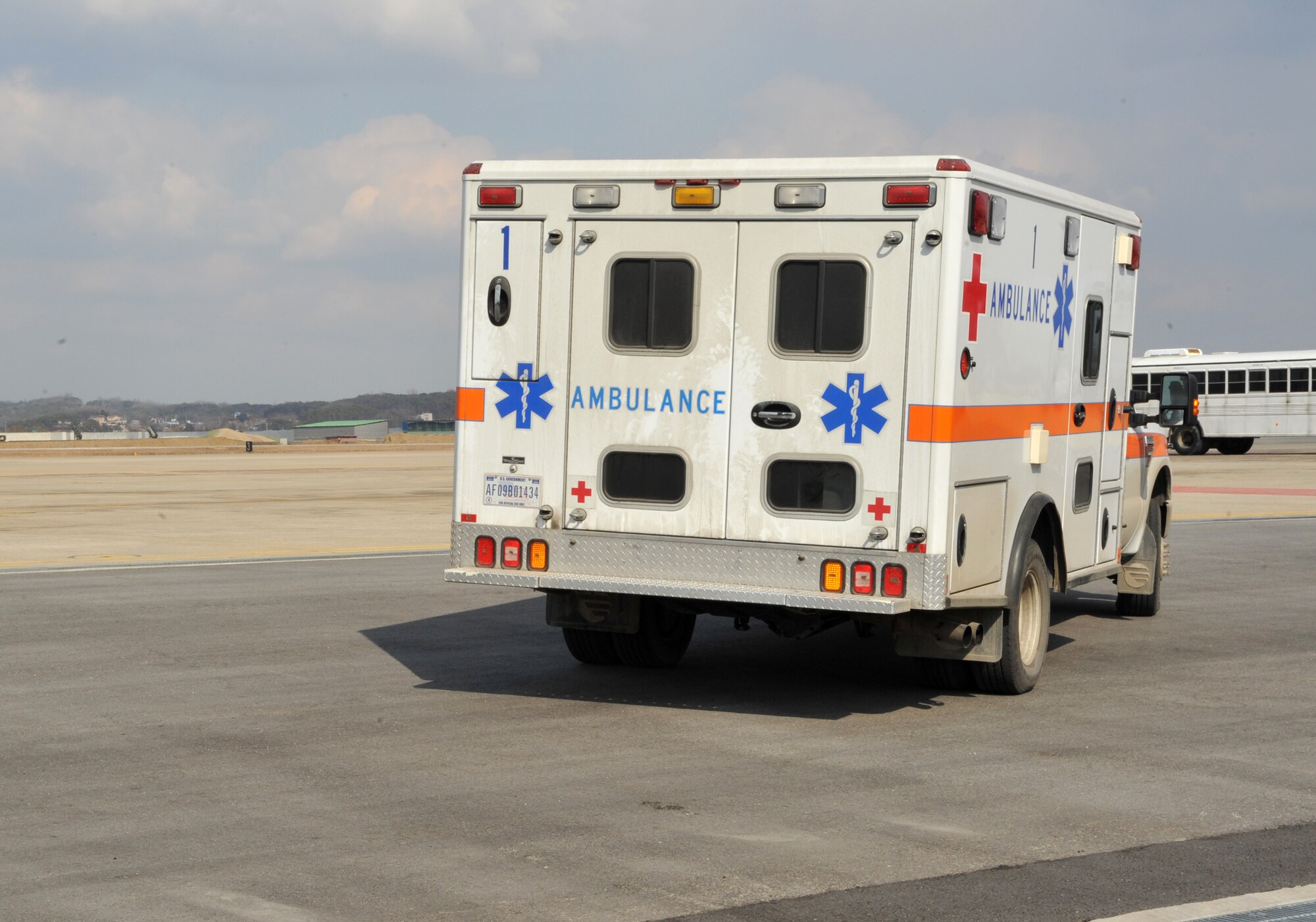 A 51st Medical Group ambulance leaves the flight line after picking up two mock casualties from a Black Hawk medevac helicopter from the 3rd General Support Aviation Battalion at U.S. Army Garrison Humphreys, Republic of Korea, during a medevac and dust-off scenario as part of Operational Readiness Exercise Beverly Midnight 14-02 at Osan Air Base, ROK, Feb. 12, 2014. OREs are a unique opportunity for medical personnel to participate in joint training with other branches of the military, mimicking operations in a real-world engagement. (U.S. Air Force photo/Airman 1st Class Ashley J. Thum)