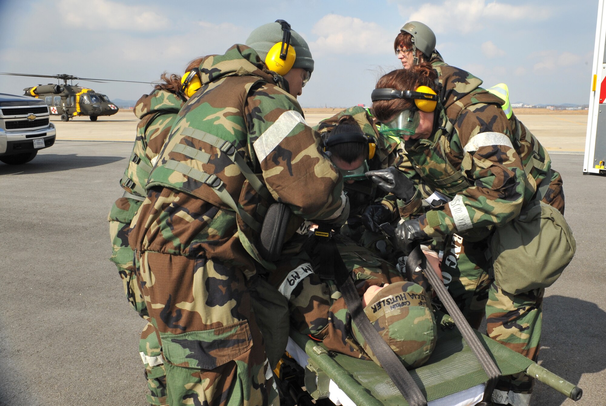 Members of the 51st Medical Group Field Response Team secure a mock casualty to a gurney during a medevac and dust-off scenario as part of Operational Readiness Exercise Beverly Midnight 14-02 at Osan Air Base, Republic of Korea, Feb. 12, 2014. A total of five mock casualties were brought to Osan during the scenario by a Black Hawk helicopter from the 3rd General Support Aviation Battalion at U.S. Army Garrison Humphries, ROK. (U.S. Air Force photo/Airman 1st Class Ashley J. Thum)