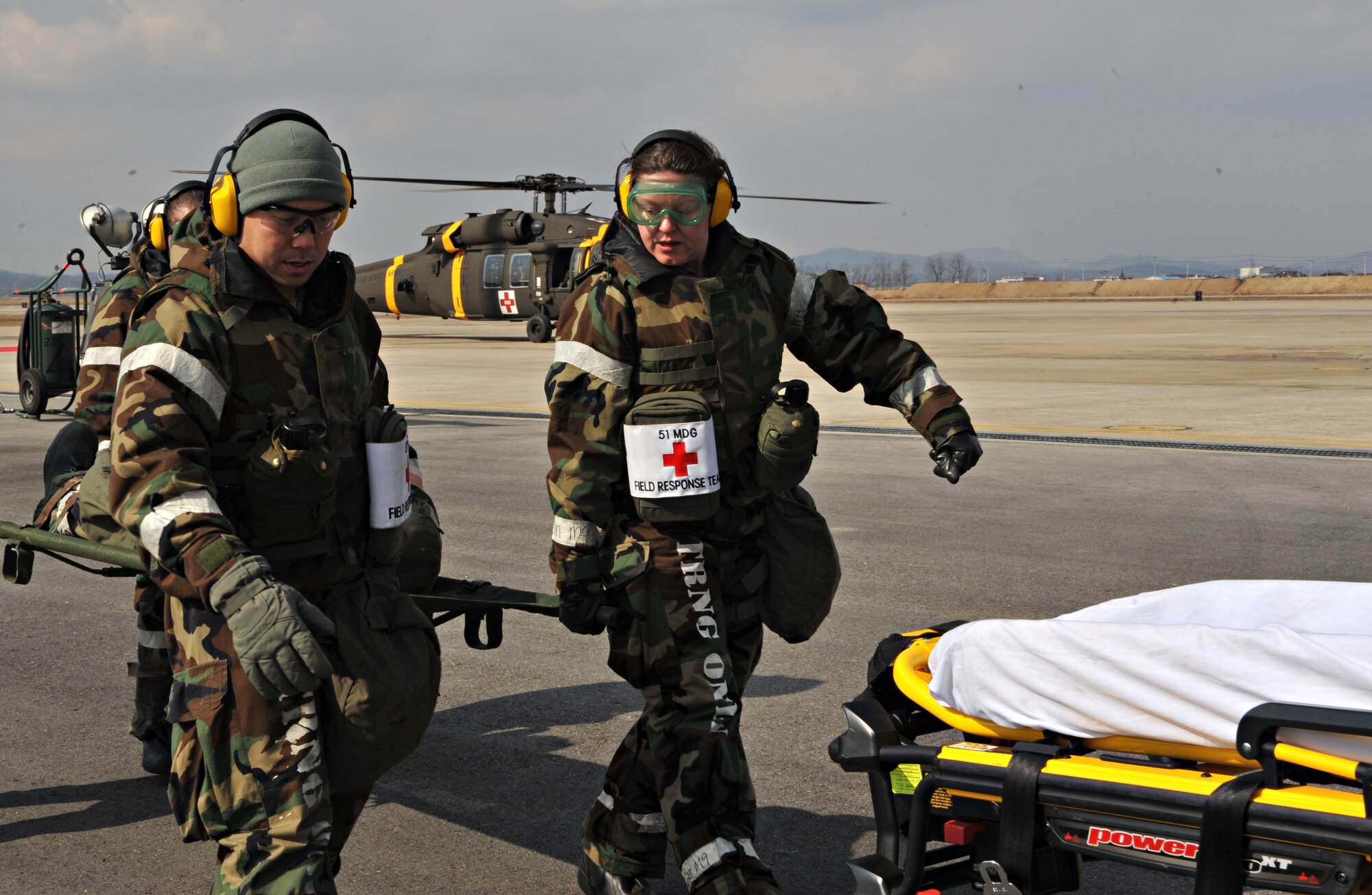 Members of the 51st Medical Group Field Response Team carry a mock casualty to a waiting ambulance during a medevac and dust-off scenario as part of Operational Readiness Exercise Beverly Midnight 14-02 at Osan Air Base, Republic of Korea, Feb. 12, 2014. During a real-world contingency operation, U.S. Army Soldiers assigned to medevac units would perform dust-offs and bring wounded ground troops to local bases with hospitals for medical care. (U.S. Air Force photo/Airman 1st Class Ashley J. Thum)