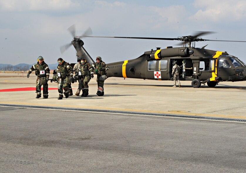 Members of the 51st Medical Group Field Response Team and a Soldier from the 3rd General Support Aviation Battalion at U.S. Army Garrison Humphreys, Republic of Korea, carry a mock casualty from a Black Hawk medevac helicopter to a waiting ambulance during a medevac and dust-off scenario as part of Operational Readiness Exercise Beverly Midnight 14-02 at Osan Air Base, ROK, Feb. 12, 2014. Soldiers from the 3-2 GSAB practiced picking up mock casualties from simulated ground engagements and transporting them to Osan for medical treatment. (U.S. Air Force photo/Airman 1st Class Ashley J. Thum)