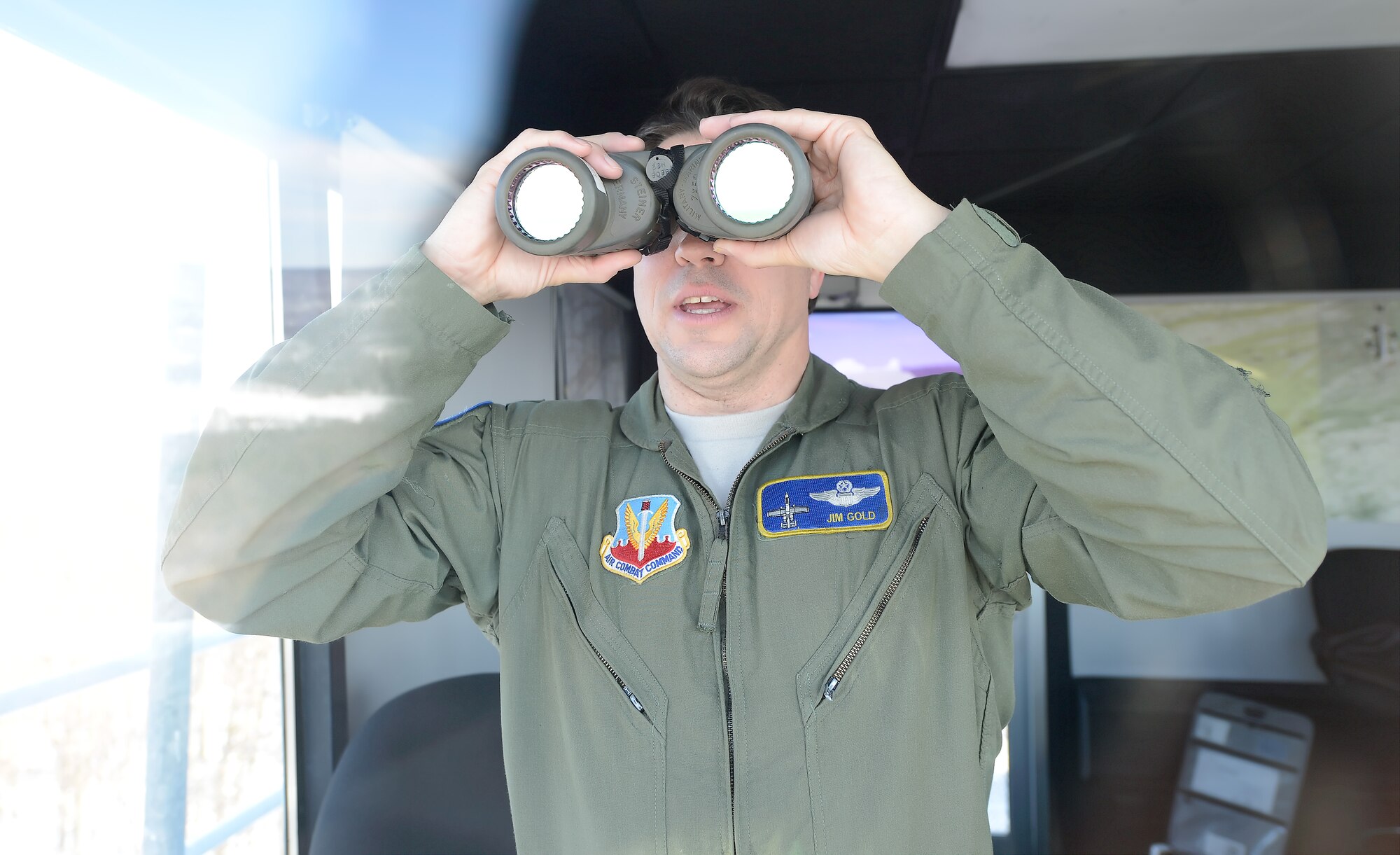 Lt. Col. Jim Gold, an attached range control officer from the 111th Air Operations Group, 111th Attack Wing, Pennsylvania Air National Guard, looks through a set of binoculars from inside a 10 story range control town while monitoring aircraft using the Bollen Live-Fire Range Complex on Feb. 6, 2014, at Ft. Indiantown Gap, Pa. Gold is a former A-10 Thunderbolt II pilot and his years of expertise and training is now leveraged to assist others in the safe execution of training missions at Bollen Range. (U.S. Air Force photo/Greg L. Davis)