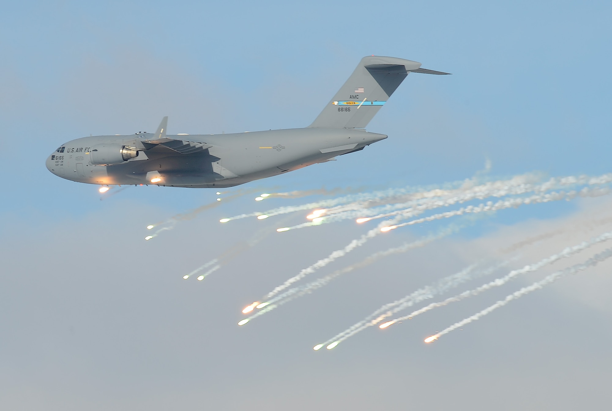 A C-17A Globemaster III from Dover Air Force Base, Del. expends countermeasure flares over the Bollen Live-Fire Range Complex, while reacting to electronic and visual threats during a training mission on Feb. 6, 2014, at Fort Indiantown Gap, Pa. The C-17A is being piloted by an Air Force Reserve crew from the 326th Airlift Squadron from Dover AFB. (U.S. Air Force photo/Greg L. Davis)