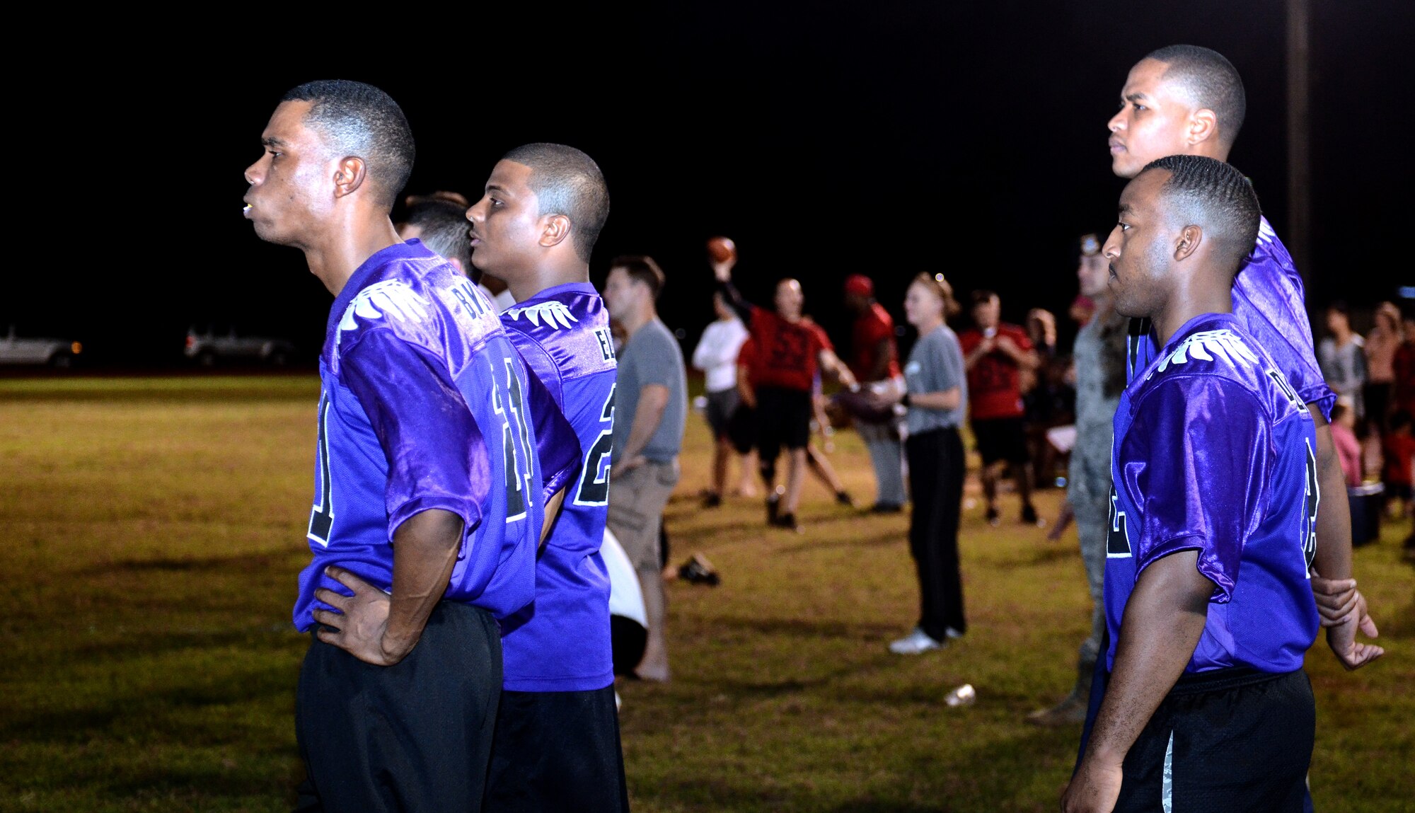 Players from the 36th Security Forces Squadron watch from the sidelines during an intramural flag football playoff game between 36th SFS and 736th Security Forces Squadron on Andersen Air Force Base, Guam, Jan. 14, 2014. The championship game is scheduled for Jan. 17 at 6 p.m. (U.S. Air Force photo by Airman 1st Class Mariah Haddenham/Released)